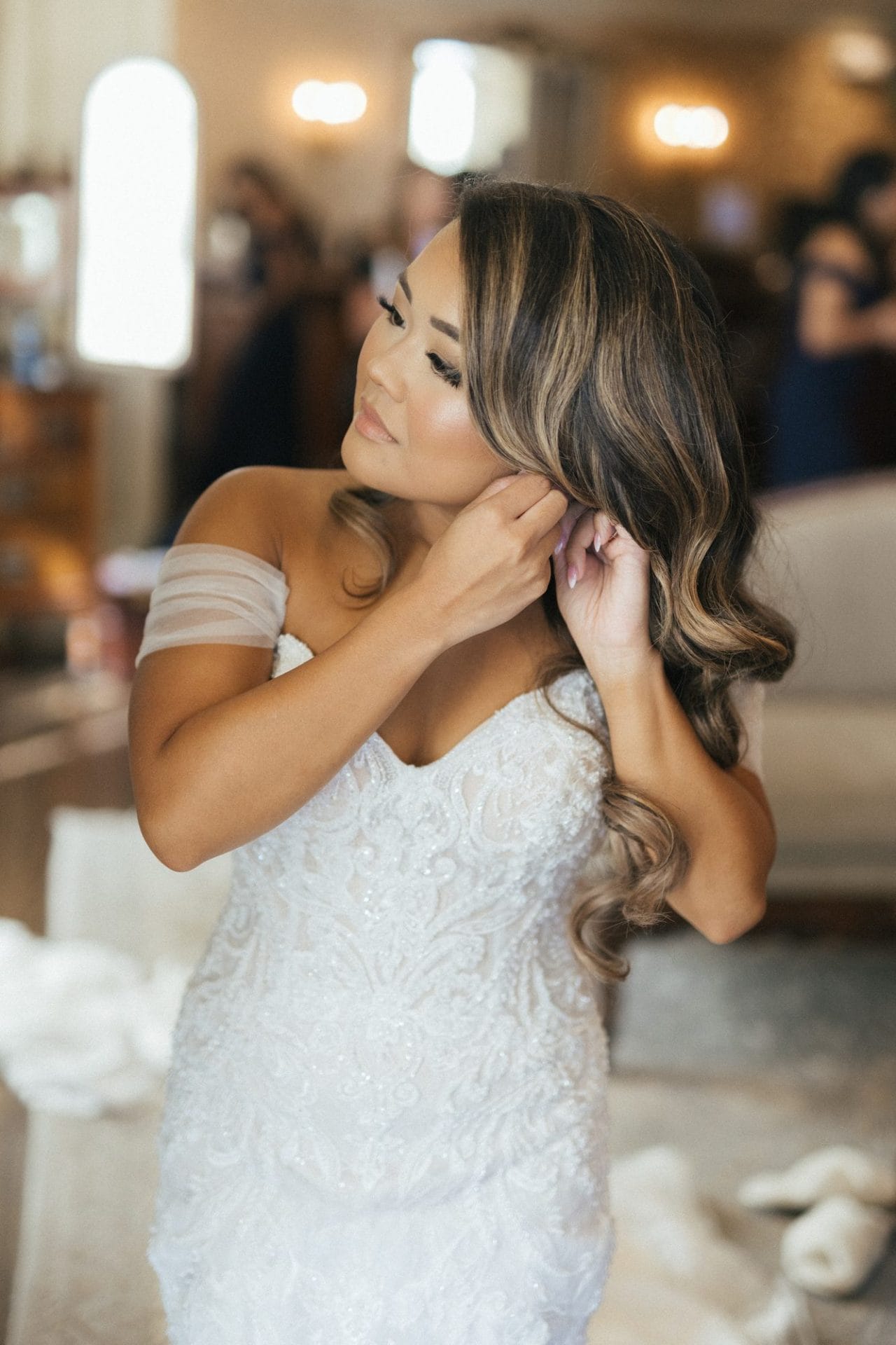 Chelsea's bridesmaids helping her into her dress