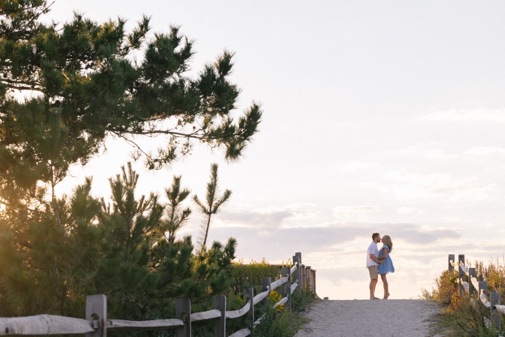 Couple walking Sunset Beach in Cape May at golden hour