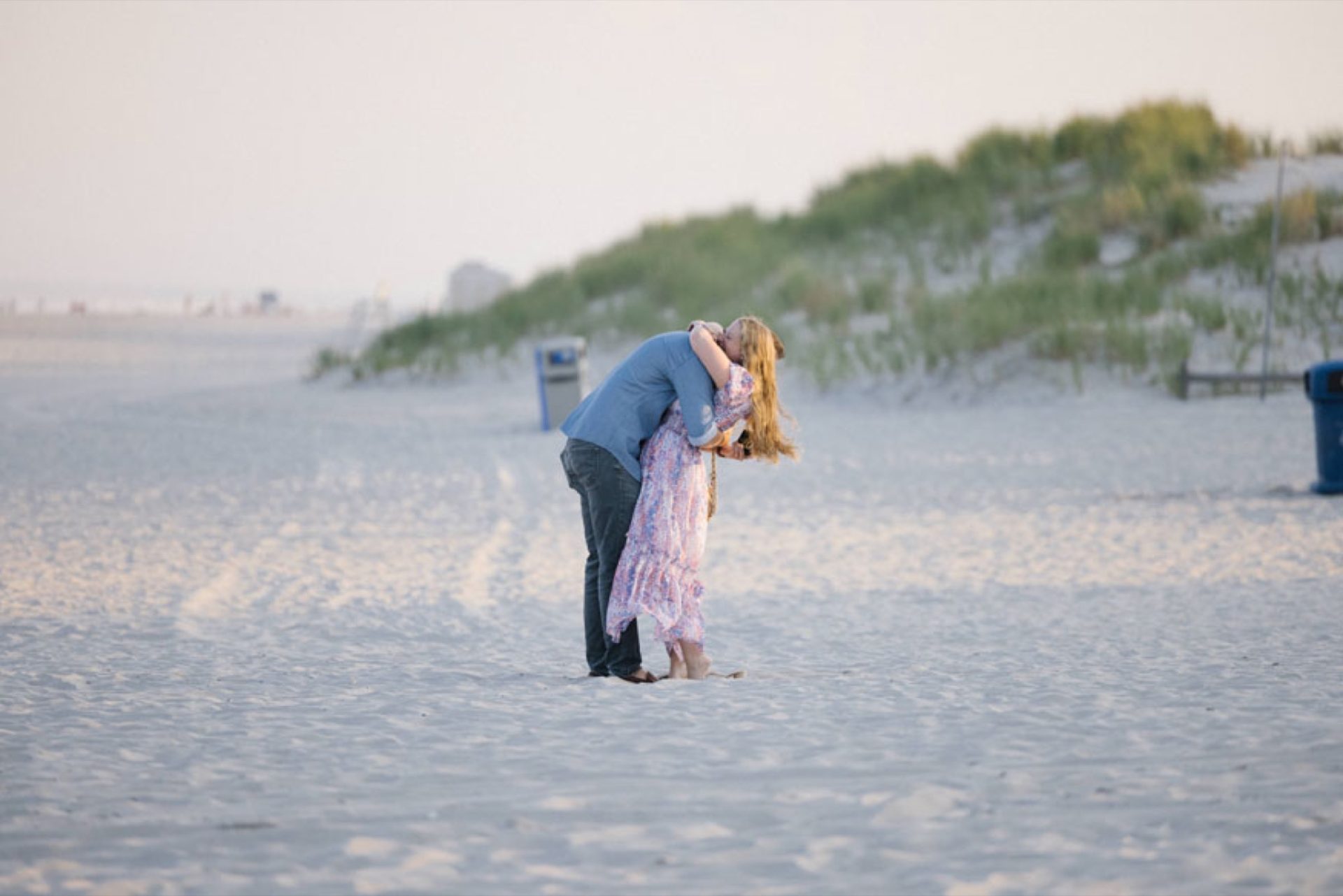 Family celebrating surprise proposal on the beach at ICONA Avalon in Avalon NJ