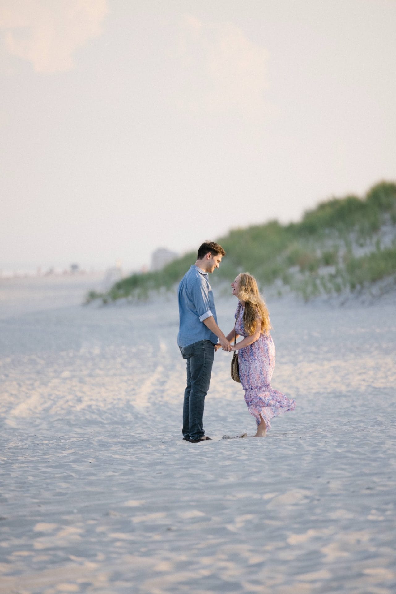 Groom-to-be walking on Avalon NJ beach before surprise proposal at sunset