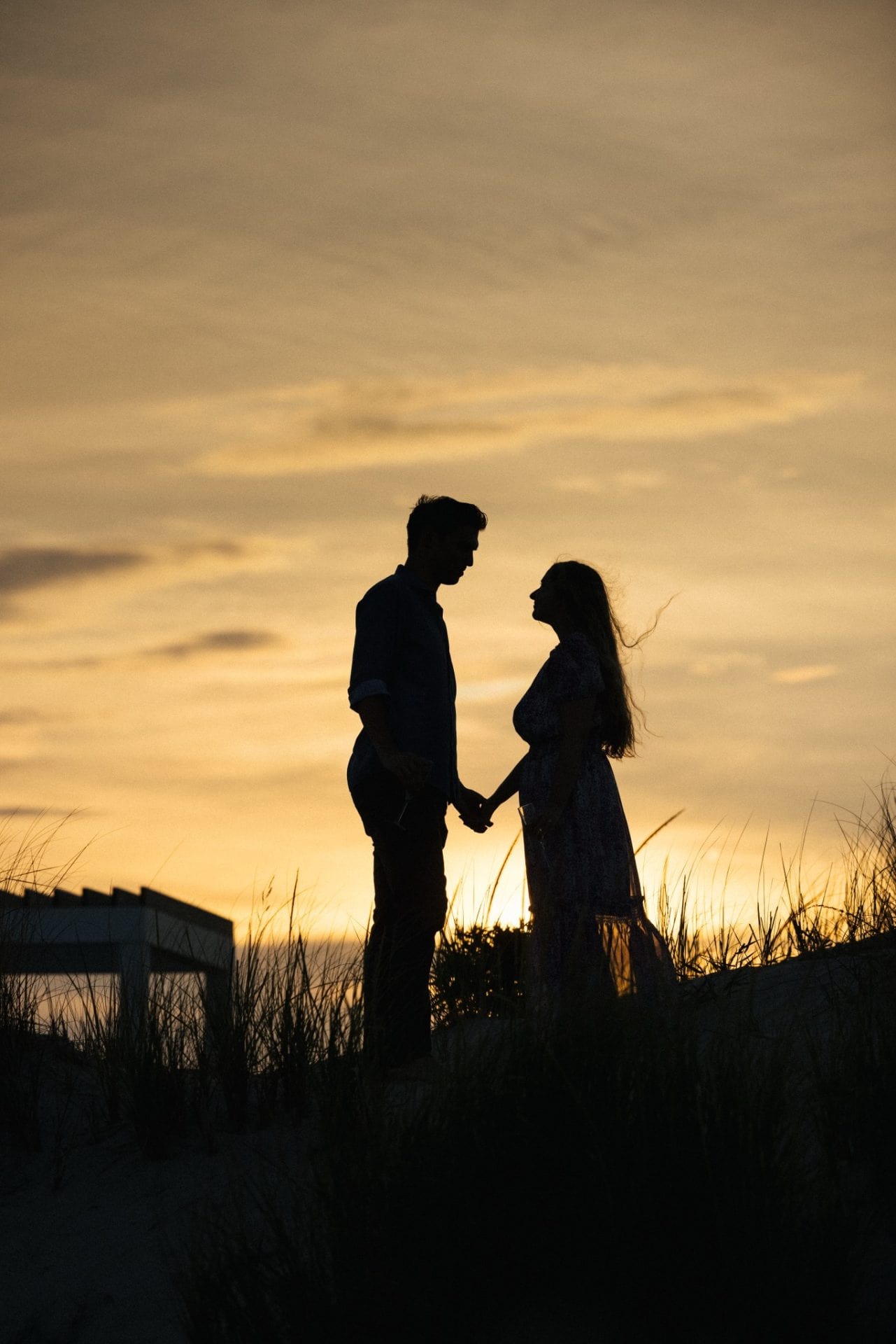 Couple laughing together on the beach after surprise proposal at ICONA Avalon NJ