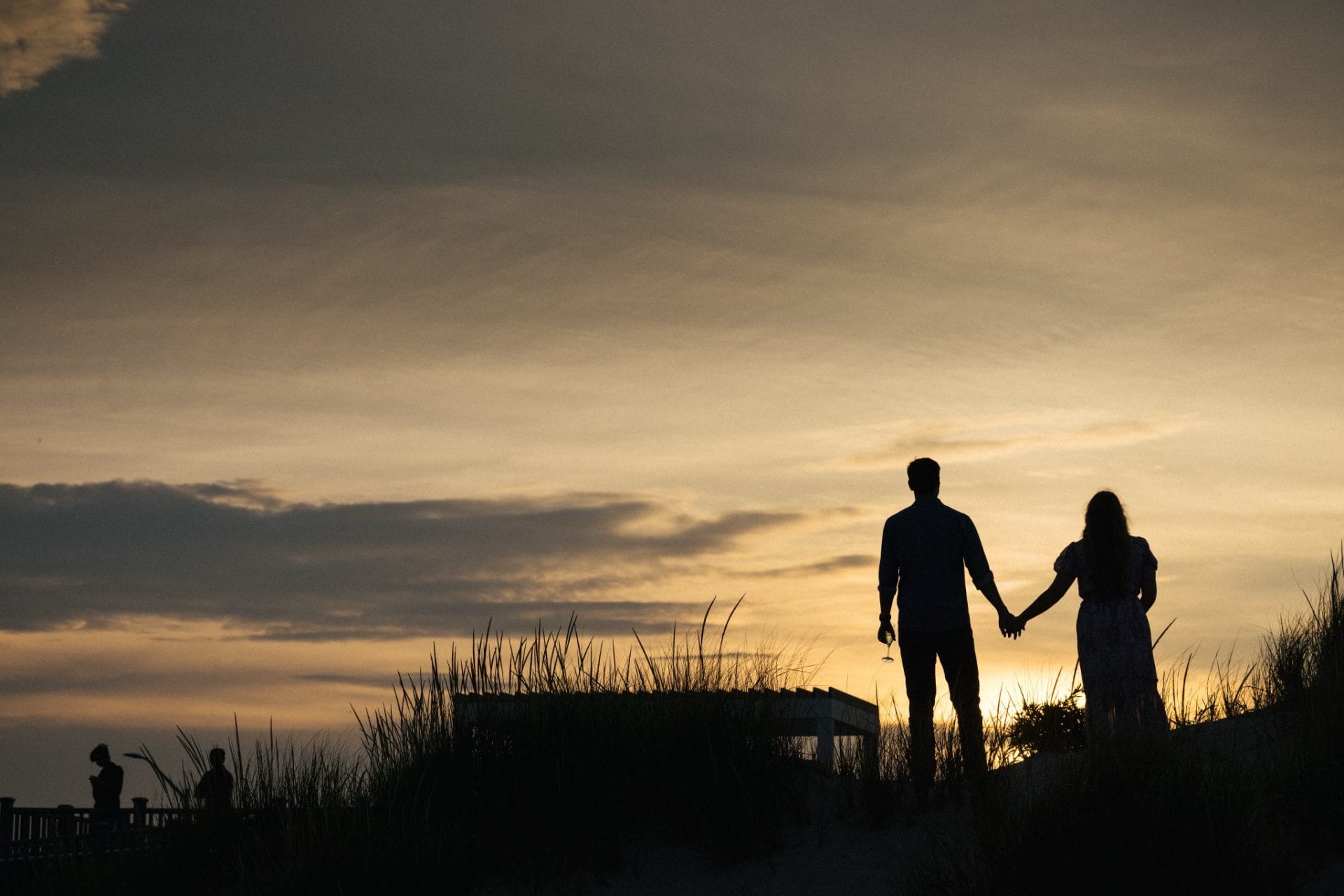 Romantic sunset photo of couple on the beach after proposal at ICONA Avalon Avalon NJ