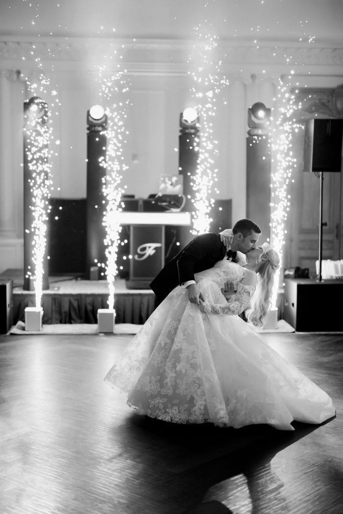 Janelle and Jim share a romantic dip and kiss during their first dance with cold-spark fountains at Park Chateau