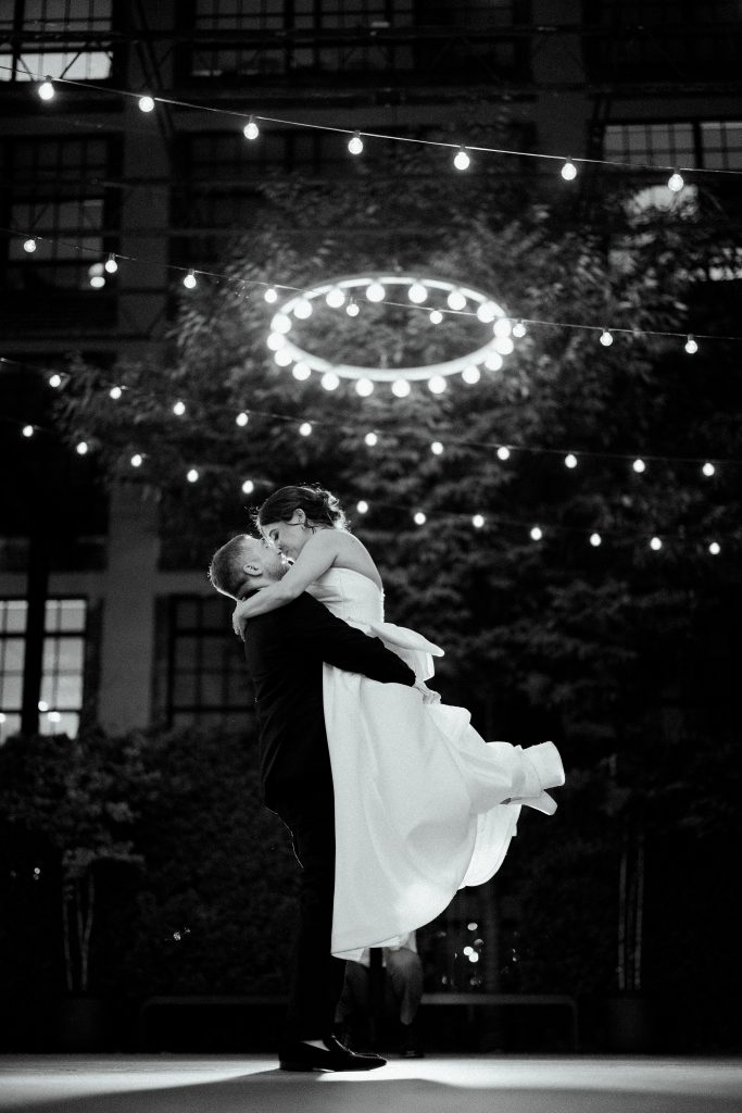 Bride and groom portrait at night under string lights