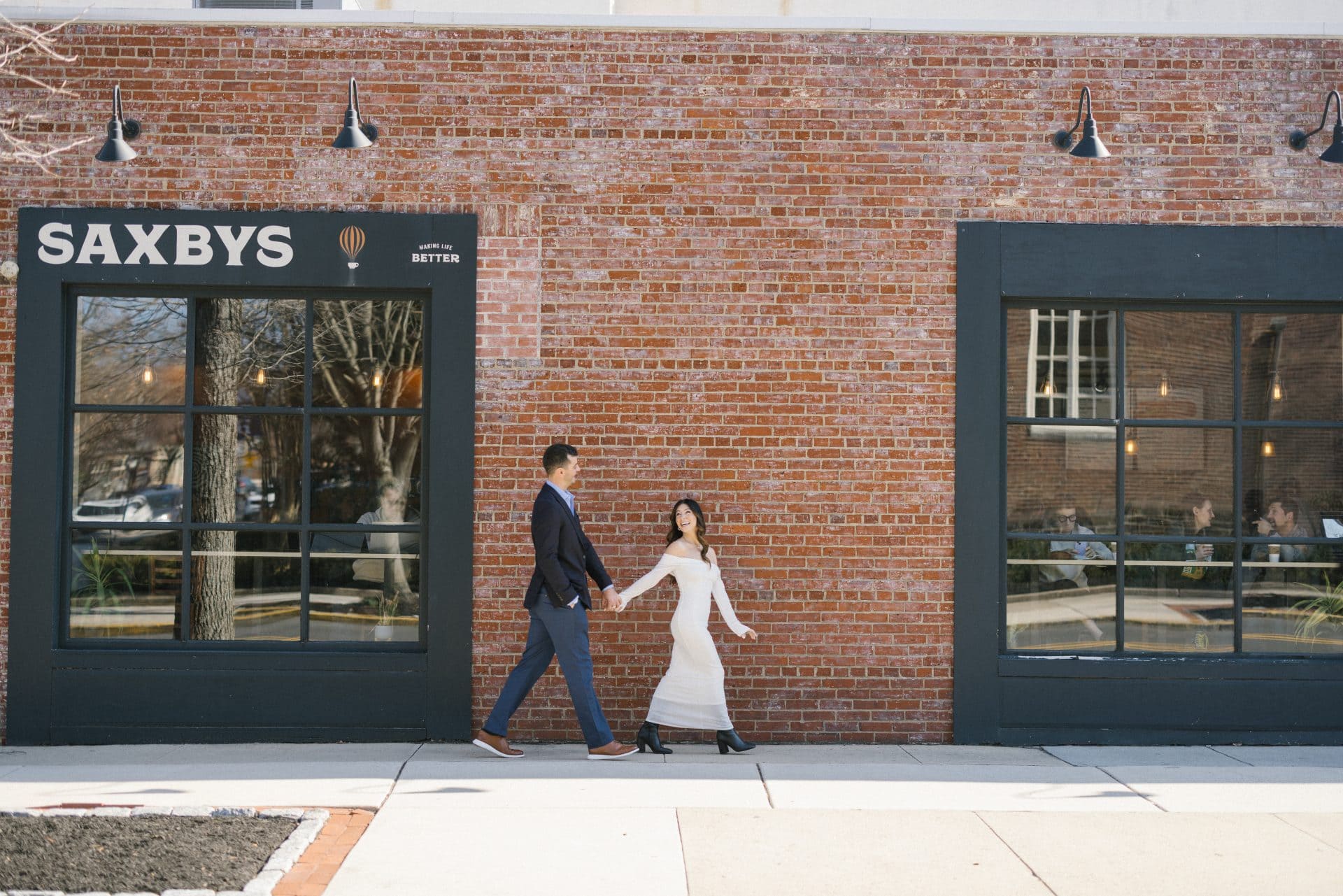 Parents hugging newly engaged couple after surprise proposal at Inkwood Books Haddonfield NJ