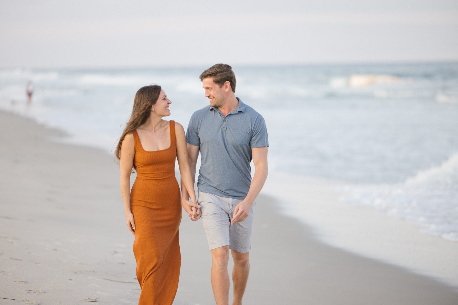 Newly engaged couple hugging on the beach after proposal in LBI, New Jersey
