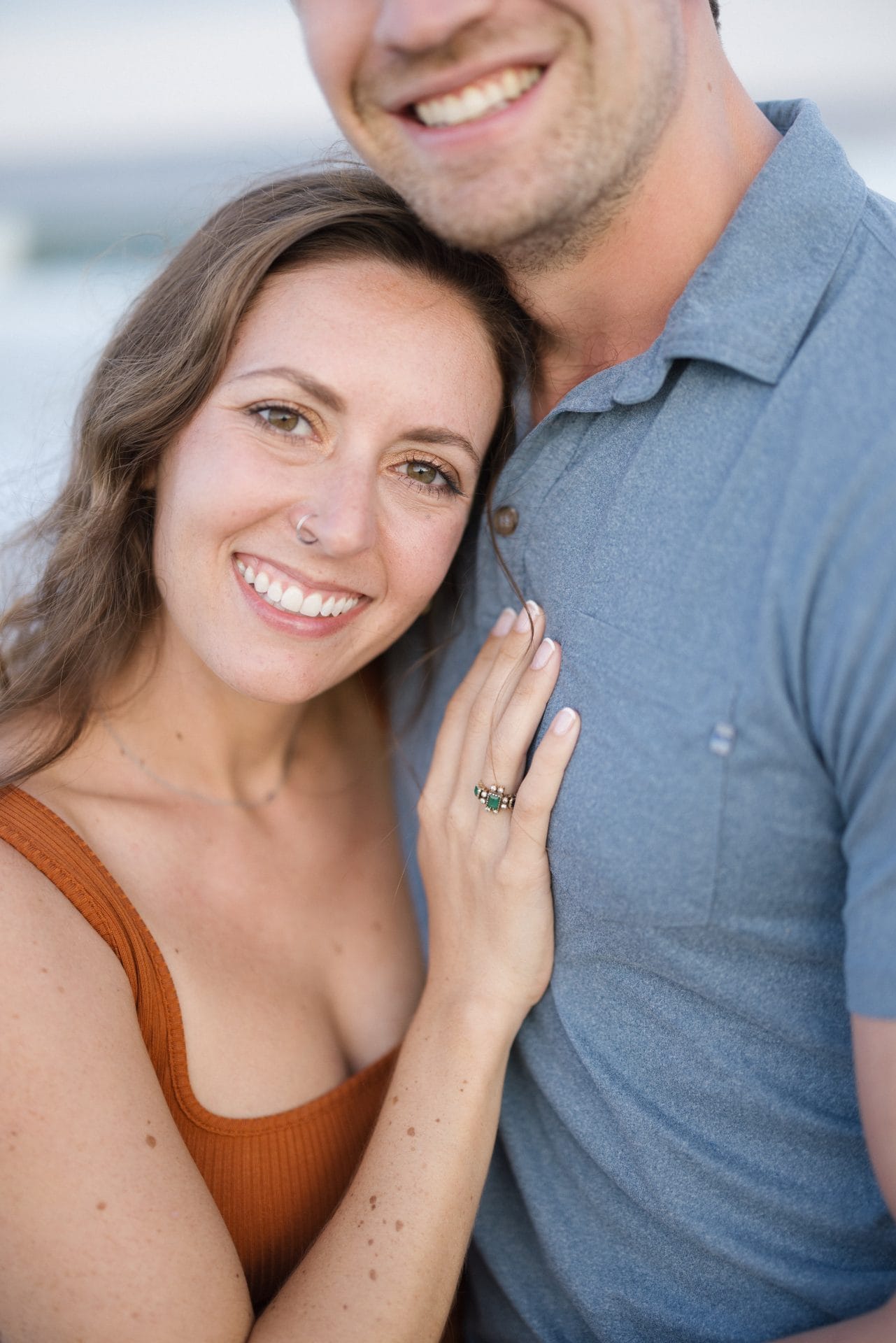 Laughing couple during engagement mini session on the beach at Long Beach Island, NJ