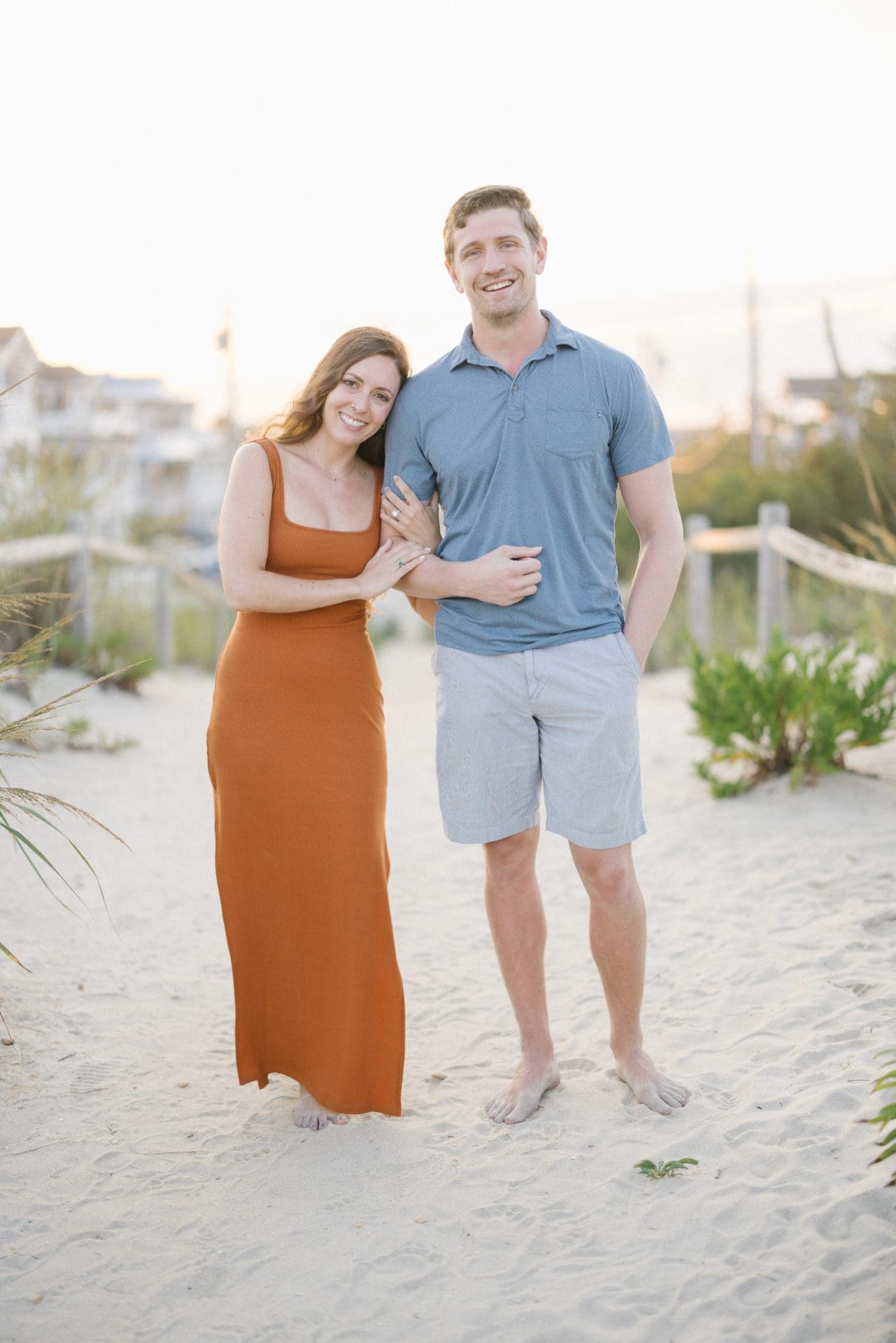 Candid engagement photo of couple at sunset on LBI beach, New Jersey