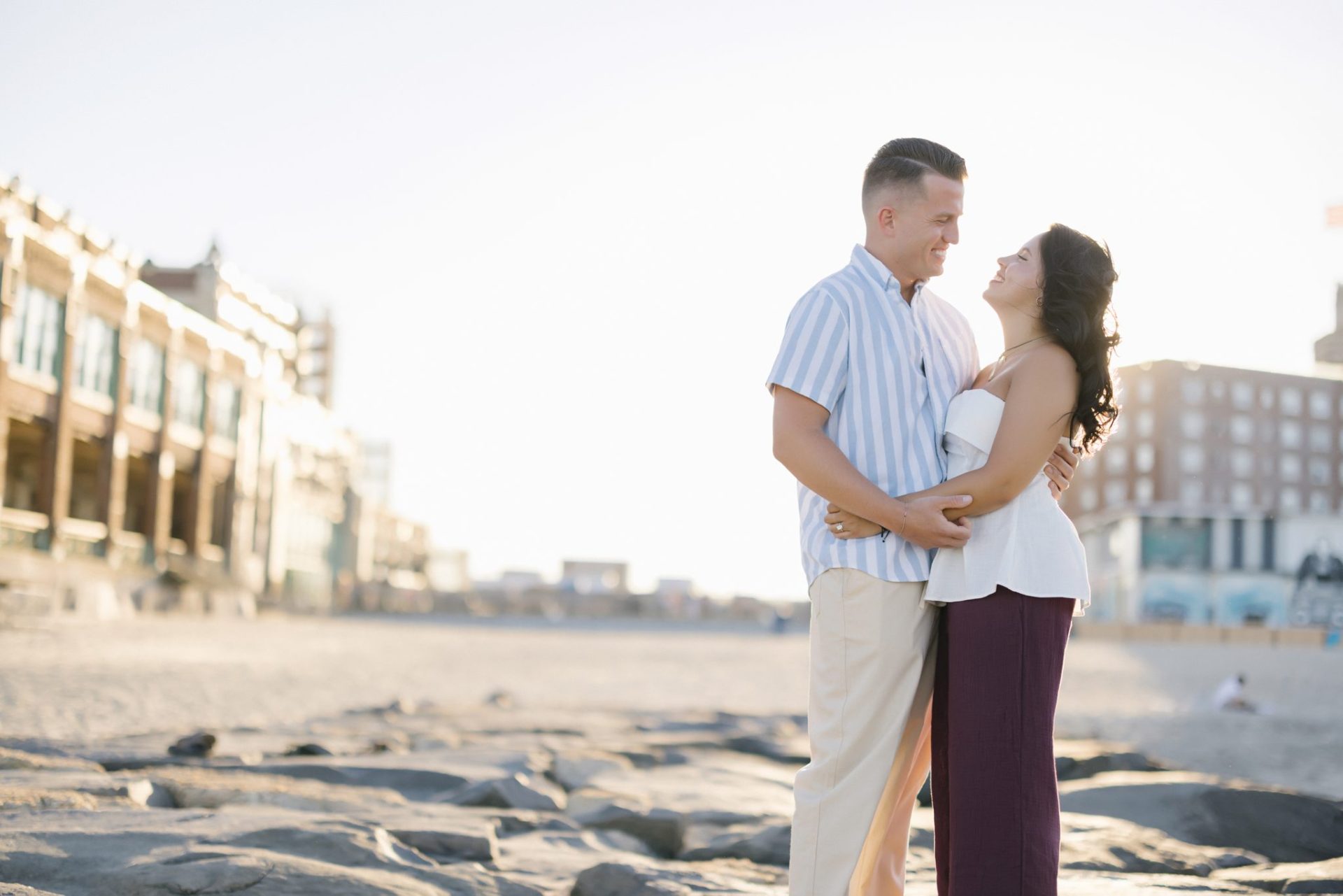 Golden hour embrace with Asbury Park Convention Hall in the background