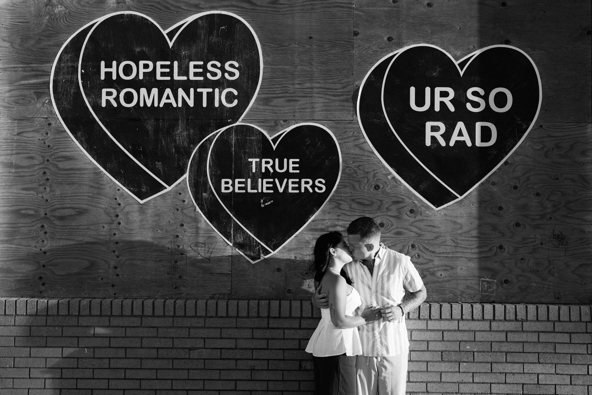 Couple kissing in front of the Hopeless Romantic mural in Asbury Park NJ