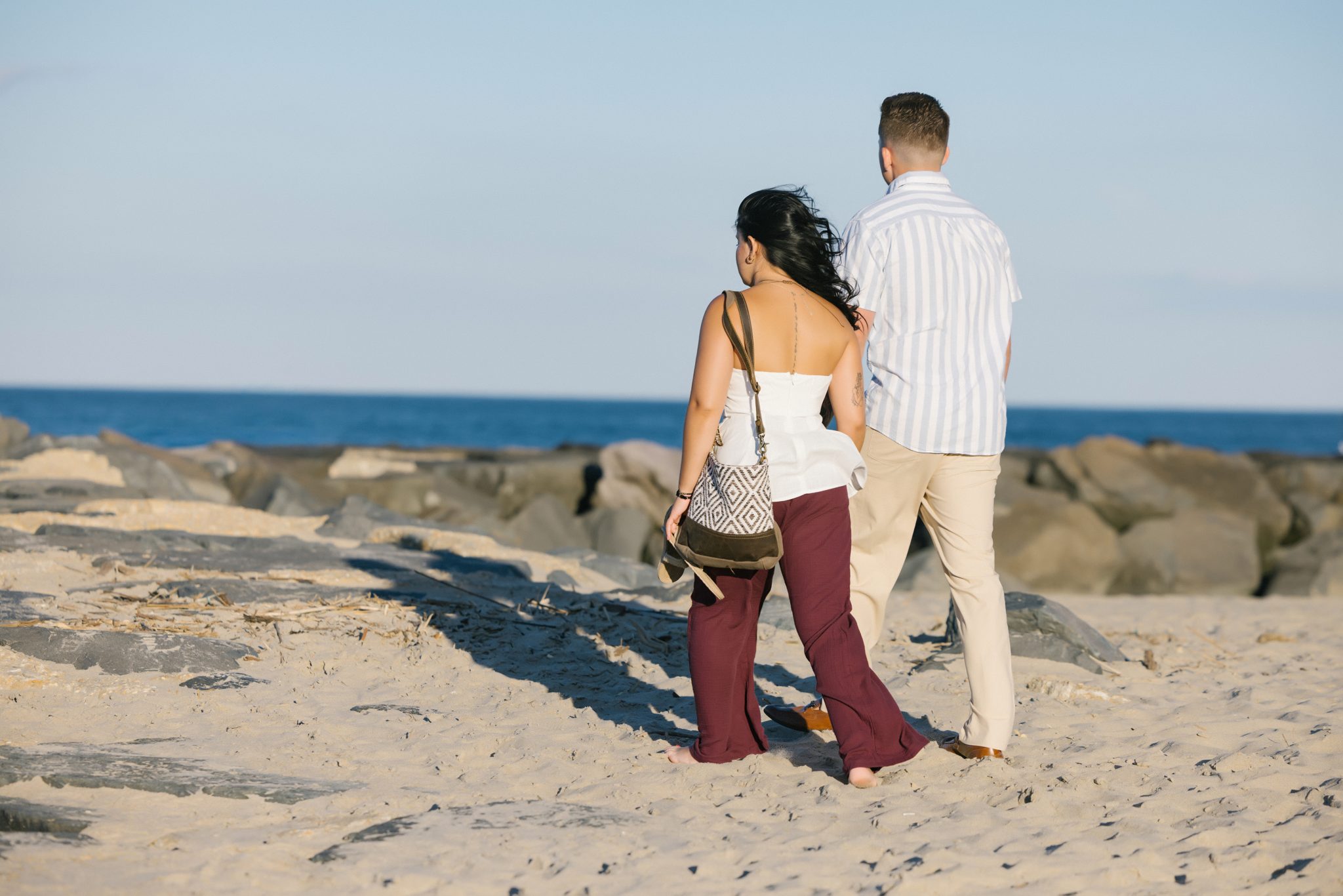 Couple walking toward the jetty north of Convention Hall in Asbury Park NJ