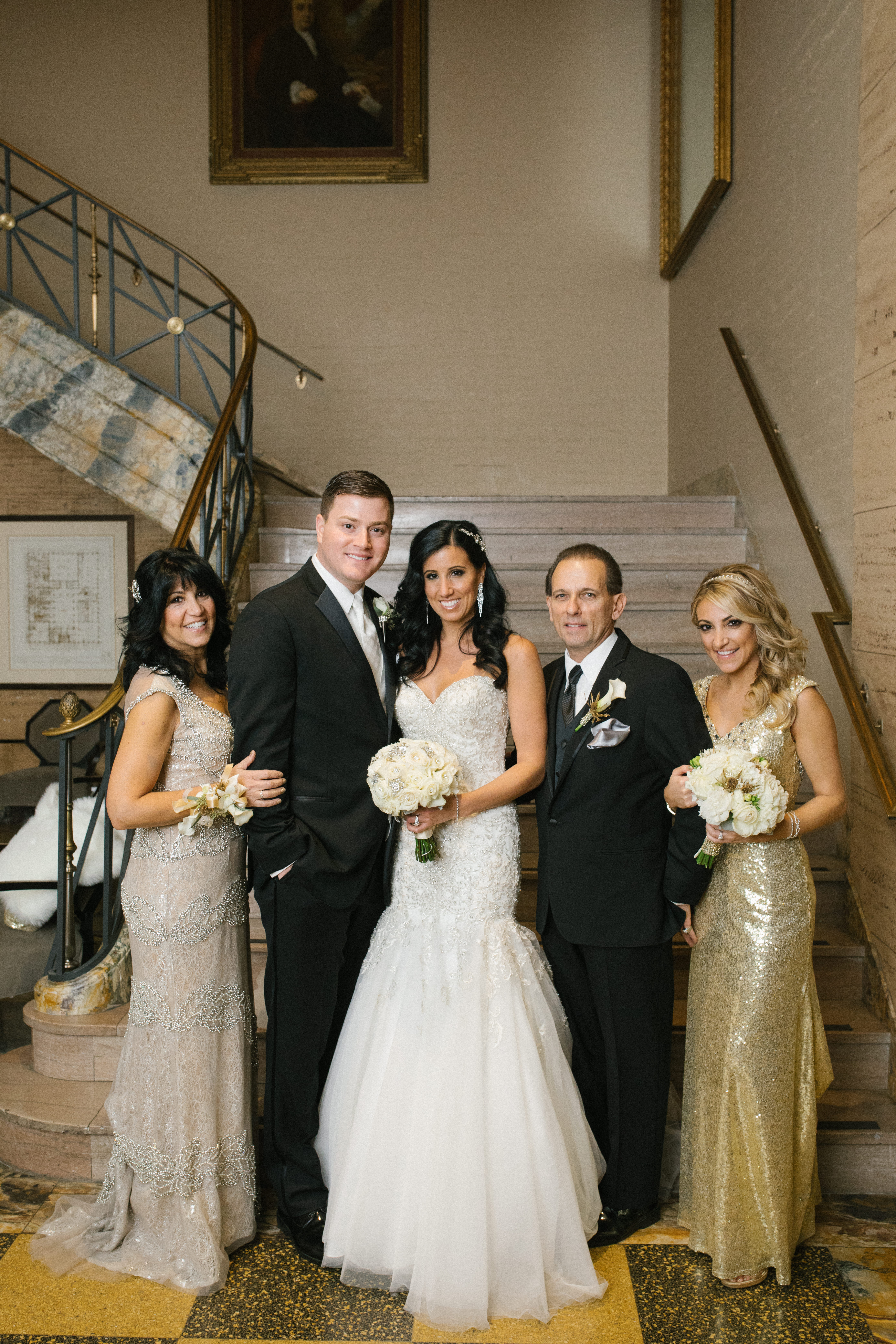 Bride and groom with parents on the front entrance staircase at the Ballroom at the Ben in Philadelphia, photographed by Jordan Brian