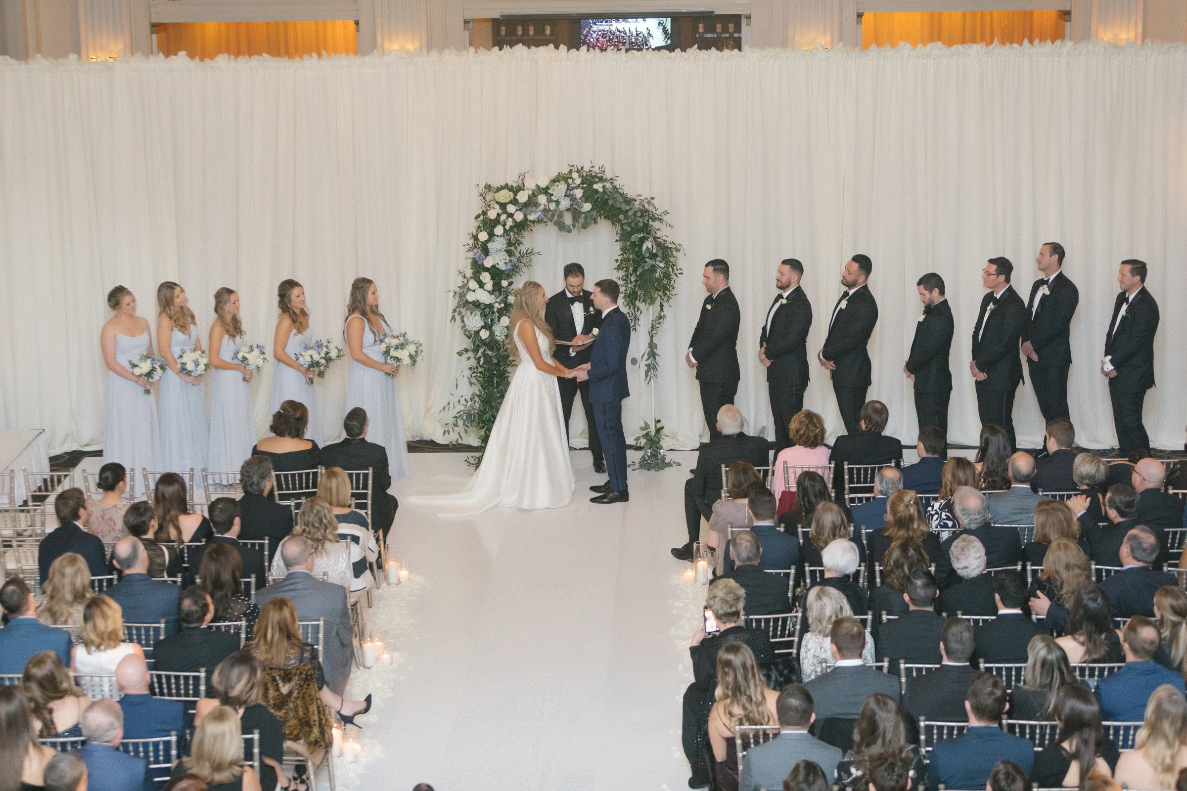 Indoor wedding ceremony beneath the chandeliers at Ballroom at the Ben