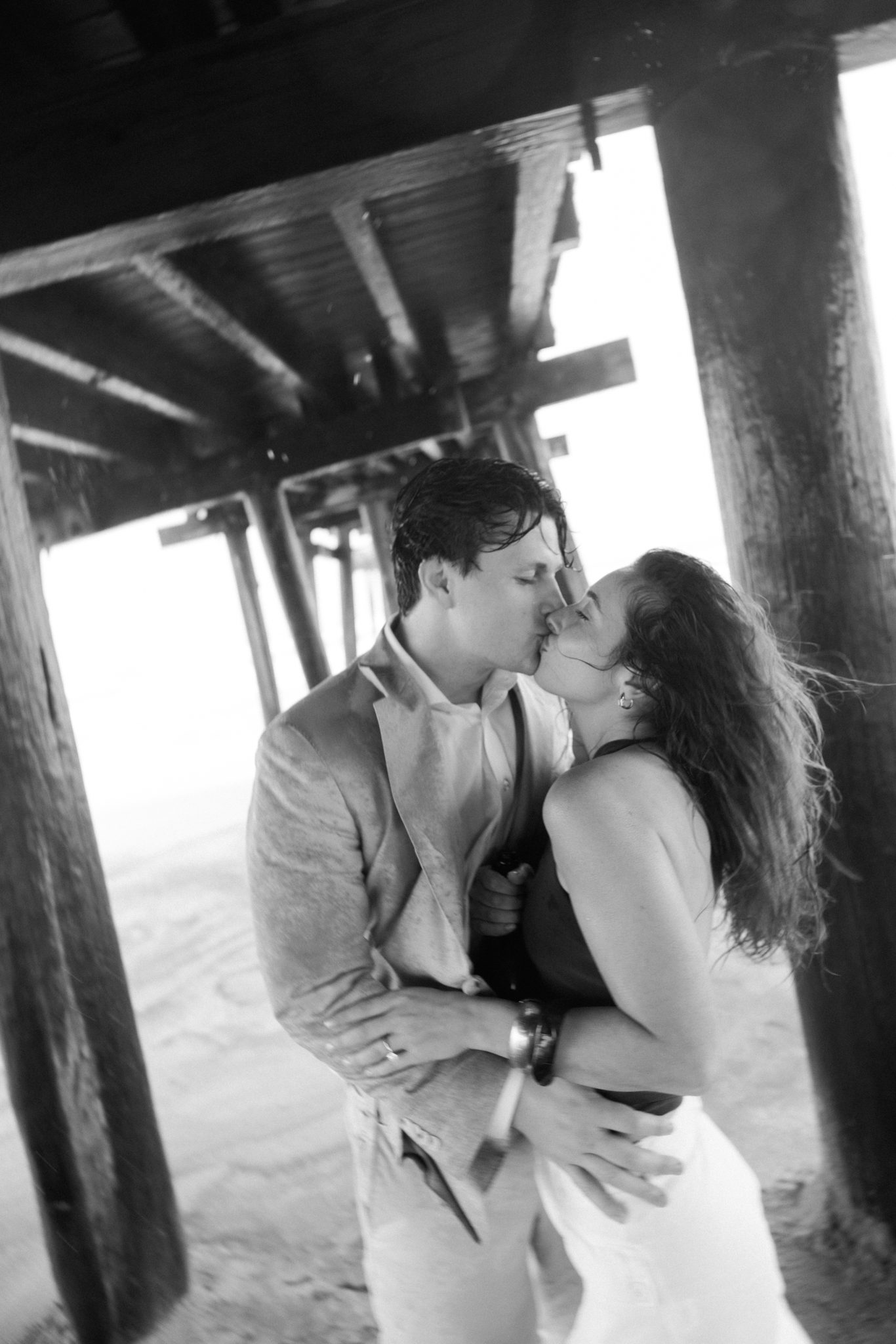 Black and white kiss after a surprise proposal in Ocean City NJ
