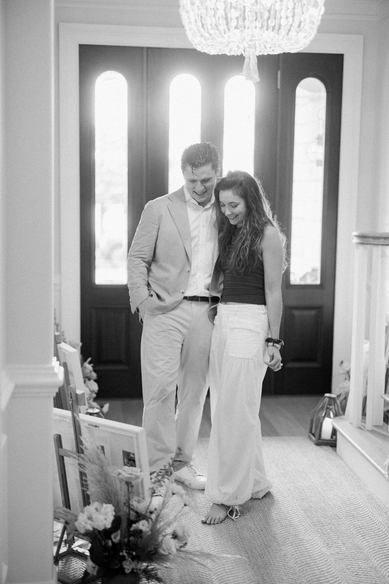 Newly engaged couple greeting guests at the door