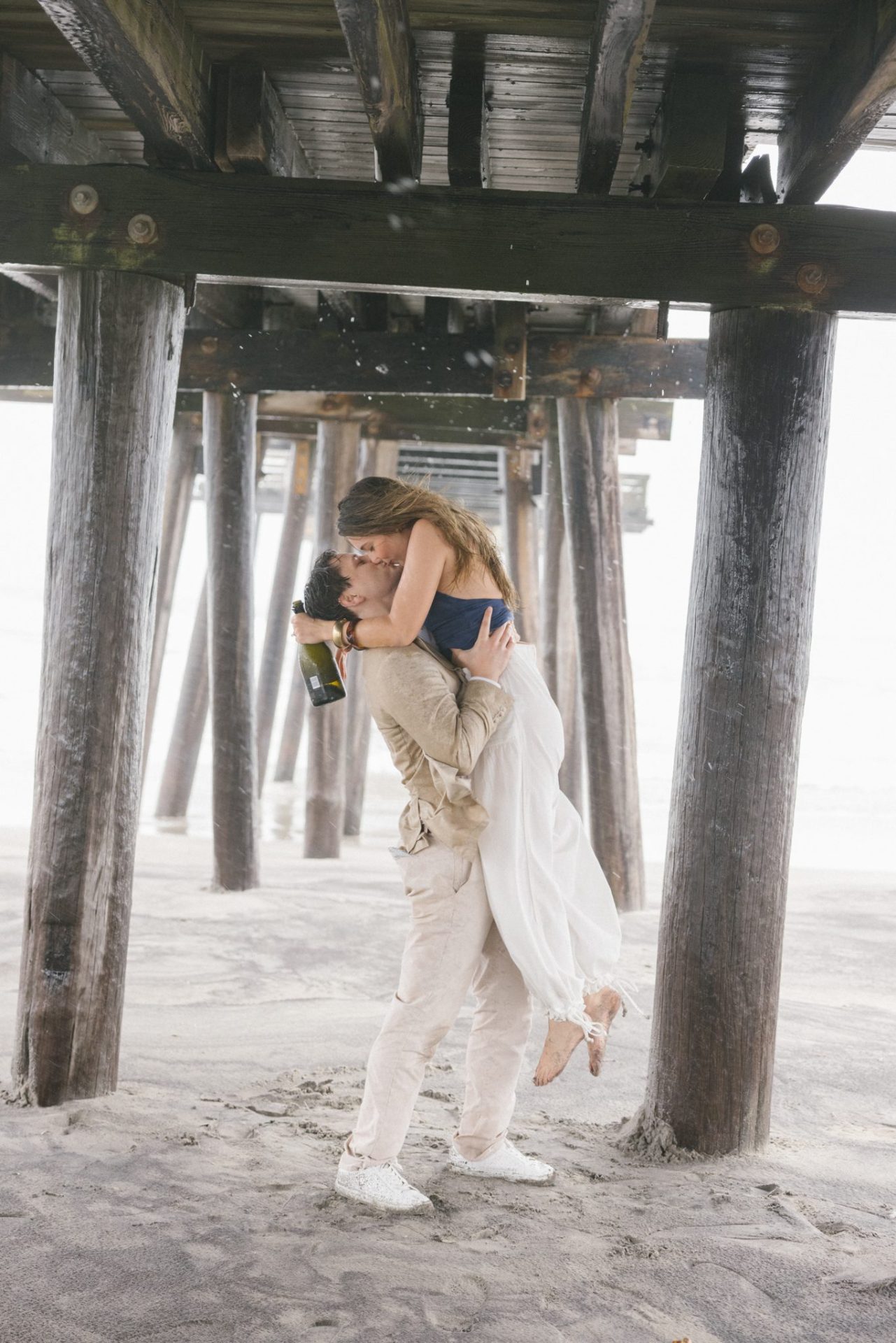 Dip kiss under the 14th Street Fishing Pier after an Ocean City NJ surprise proposal