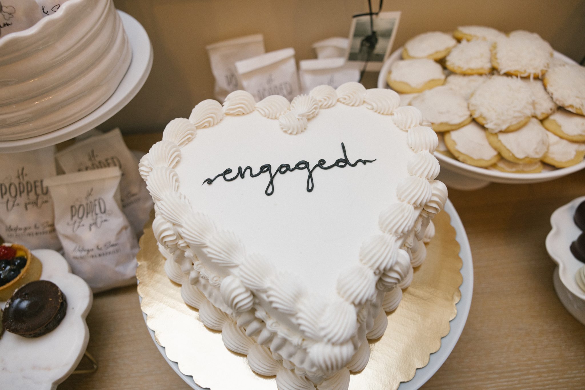 Heart shaped engaged cake and cookies at the engagement party