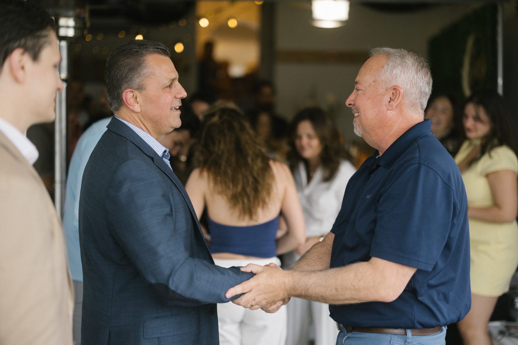 Family hugs at a surprise engagement party in Ocean City NJ