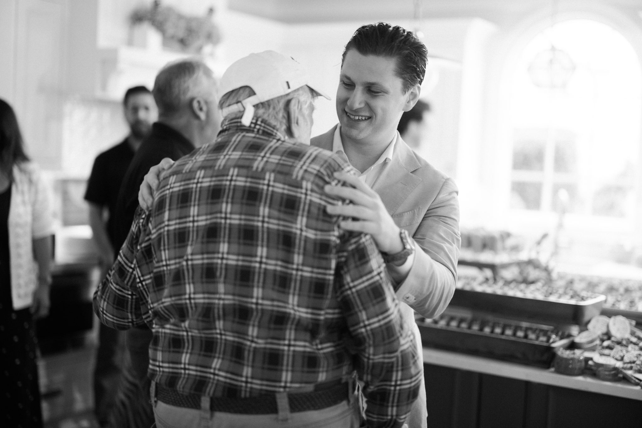 Guests embracing at the surprise engagement party