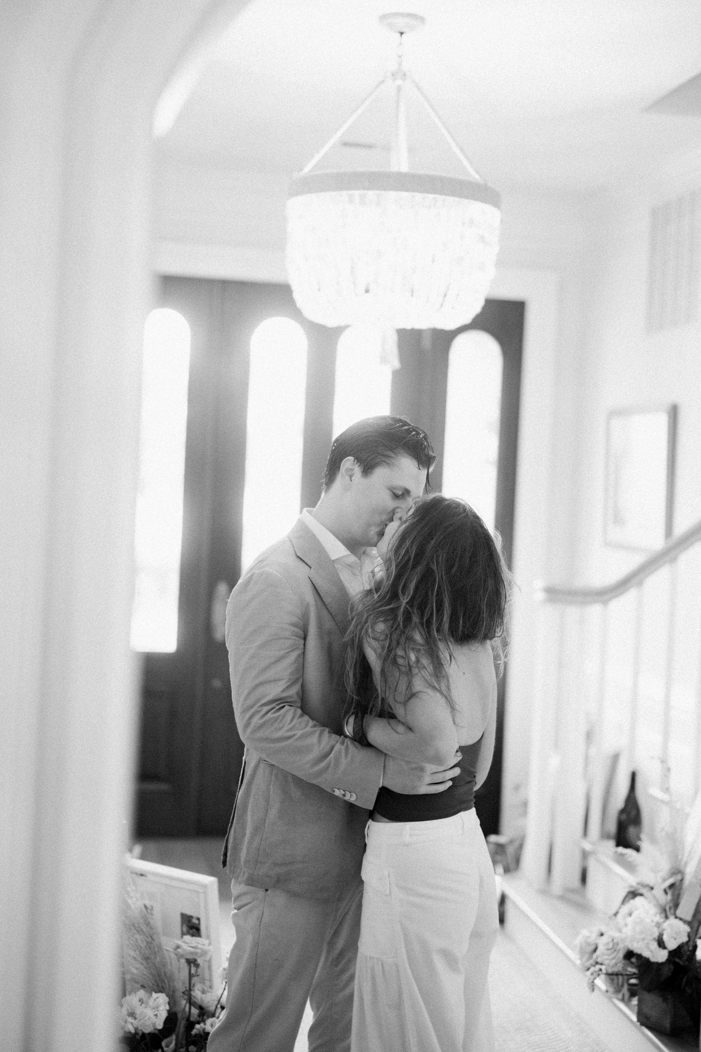 Quiet black and white kiss between the newly engaged couple