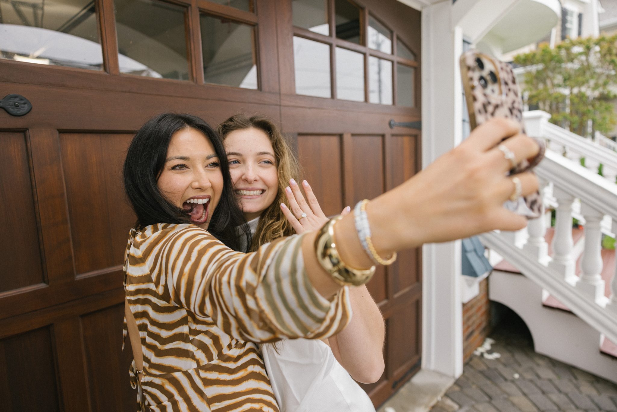 Friends taking a selfie with the newly engaged couple
