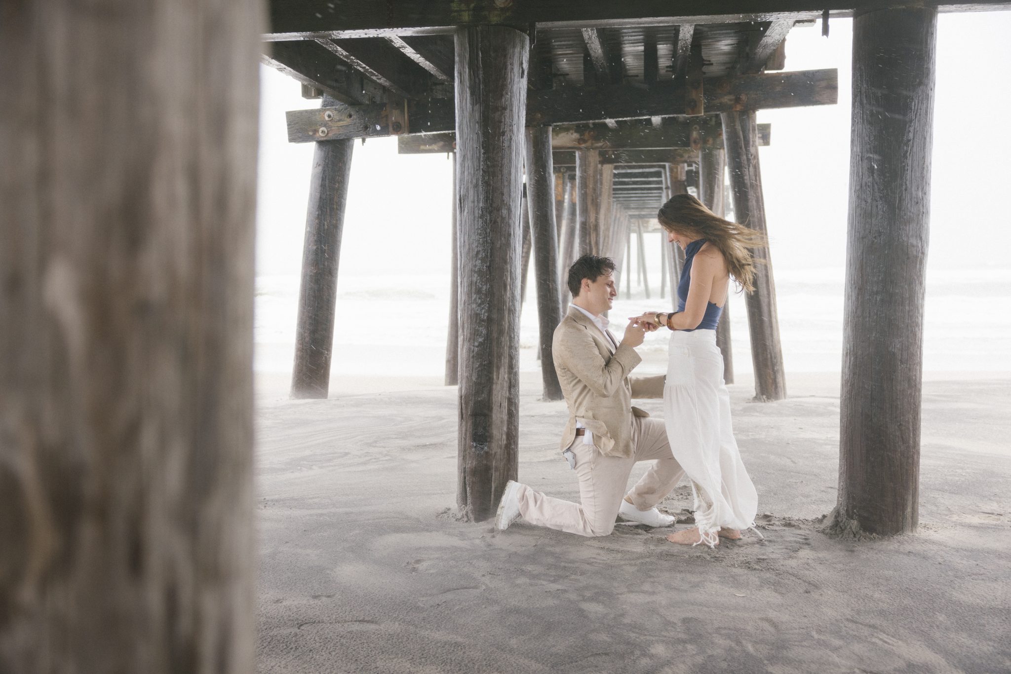 Wide view of a rainy surprise proposal under the 14th Street Fishing Pier in Ocean City NJ