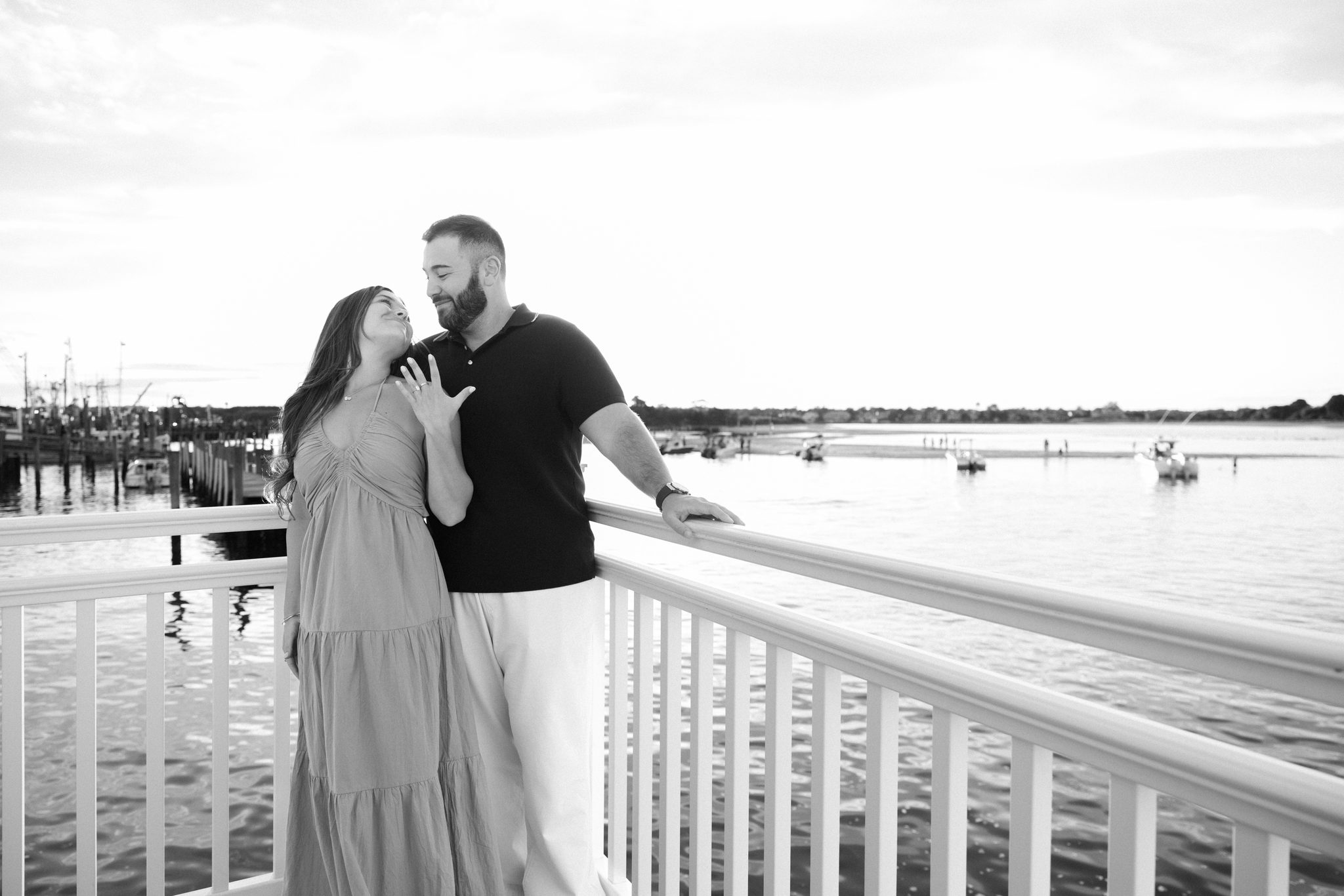 Black and white portrait of Anthony and Juliette on the Harbor Point balcony in Point Pleasant Beach NJ