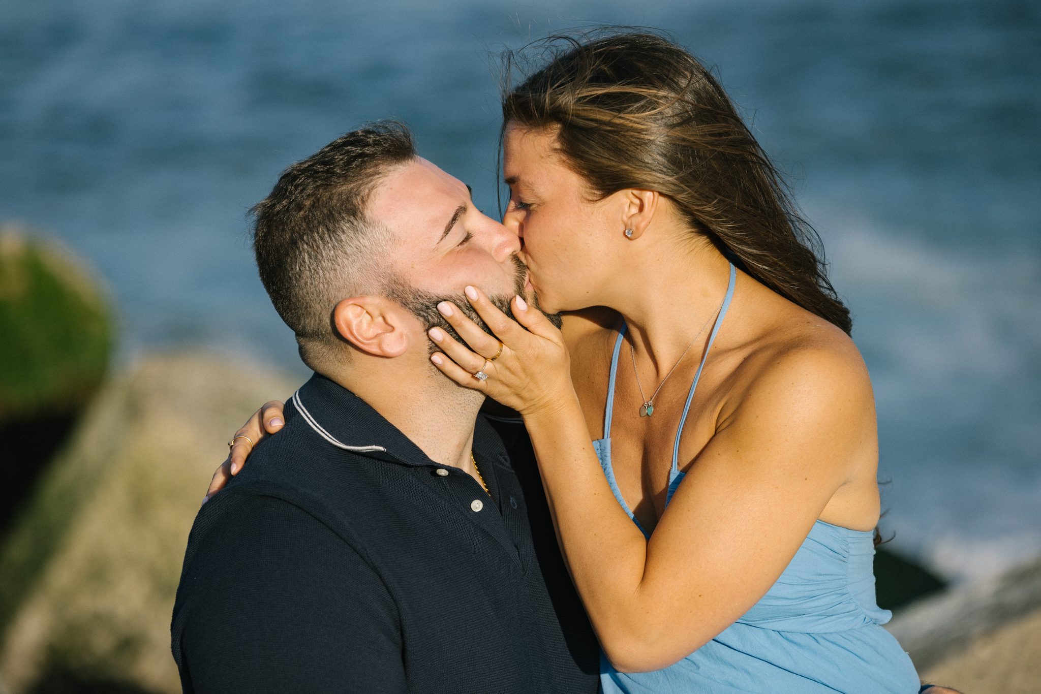 Golden hour kiss after the surprise proposal at the Manasquan Inlet in Point Pleasant Beach NJ