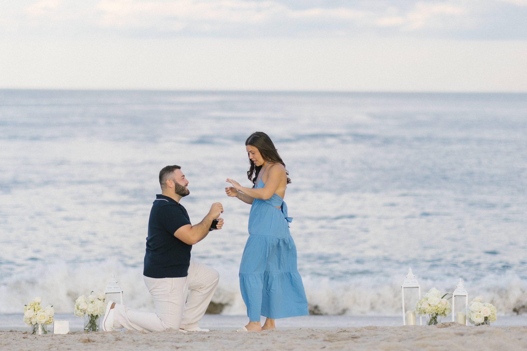Anthony placing the engagement ring on Juliette's finger during the surprise proposal in Point Pleasant Beach NJ