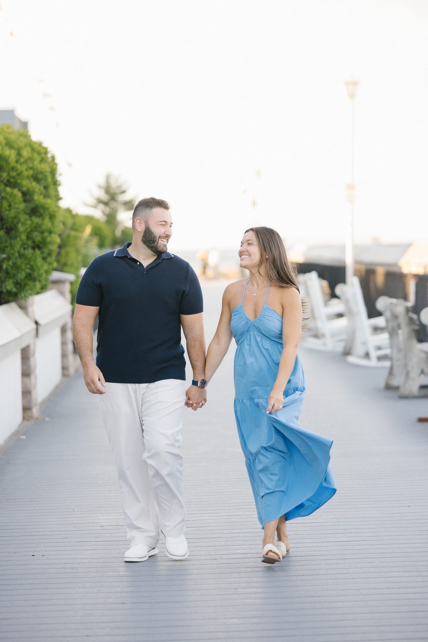 Anthony and Juliette walking the Point Pleasant Beach boardwalk by Jenkinson's at sunset toward Harbor Point