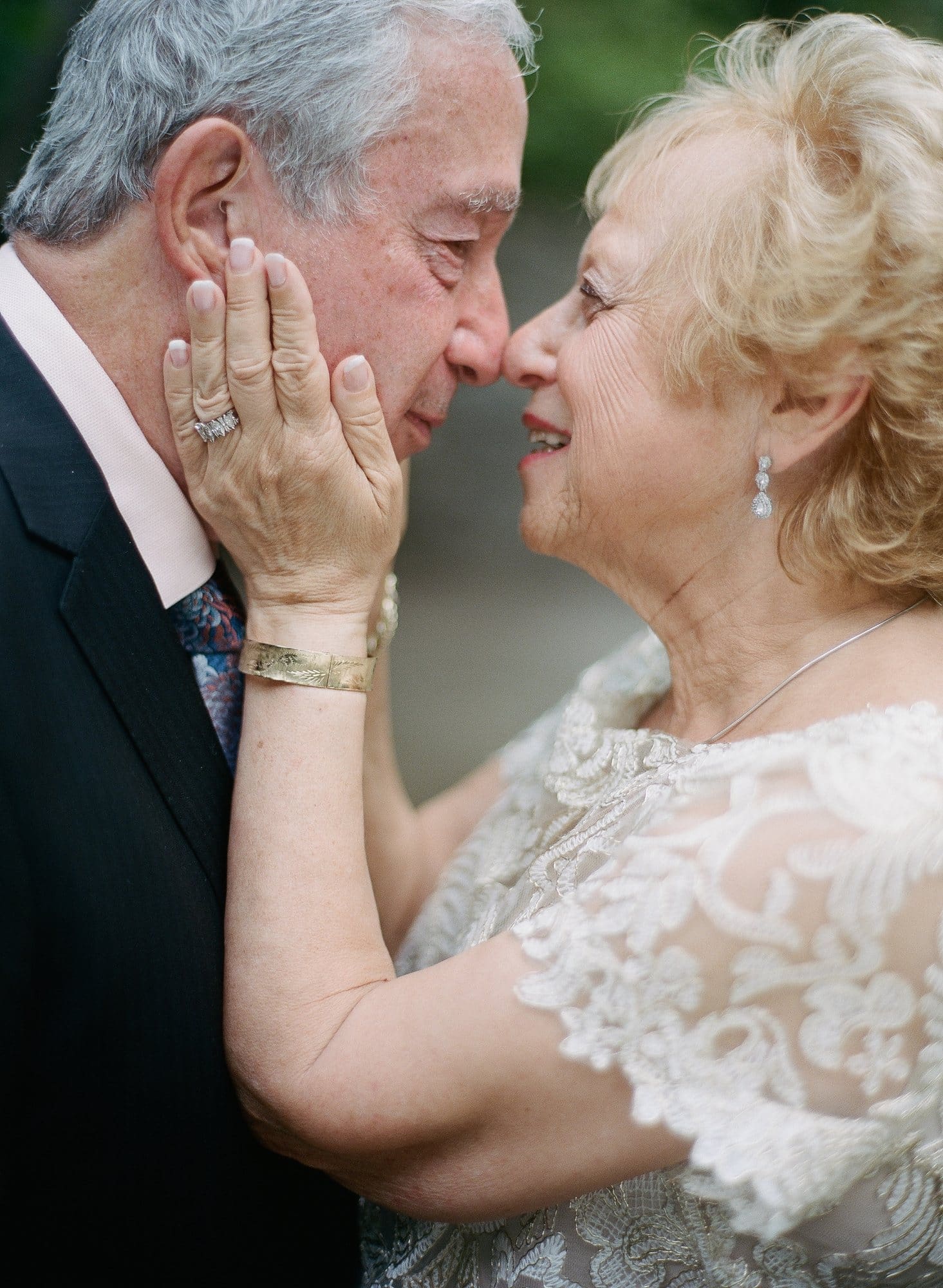 Close portrait of a husband gently holding his wife's face at their 50th wedding anniversary near Philadelphia