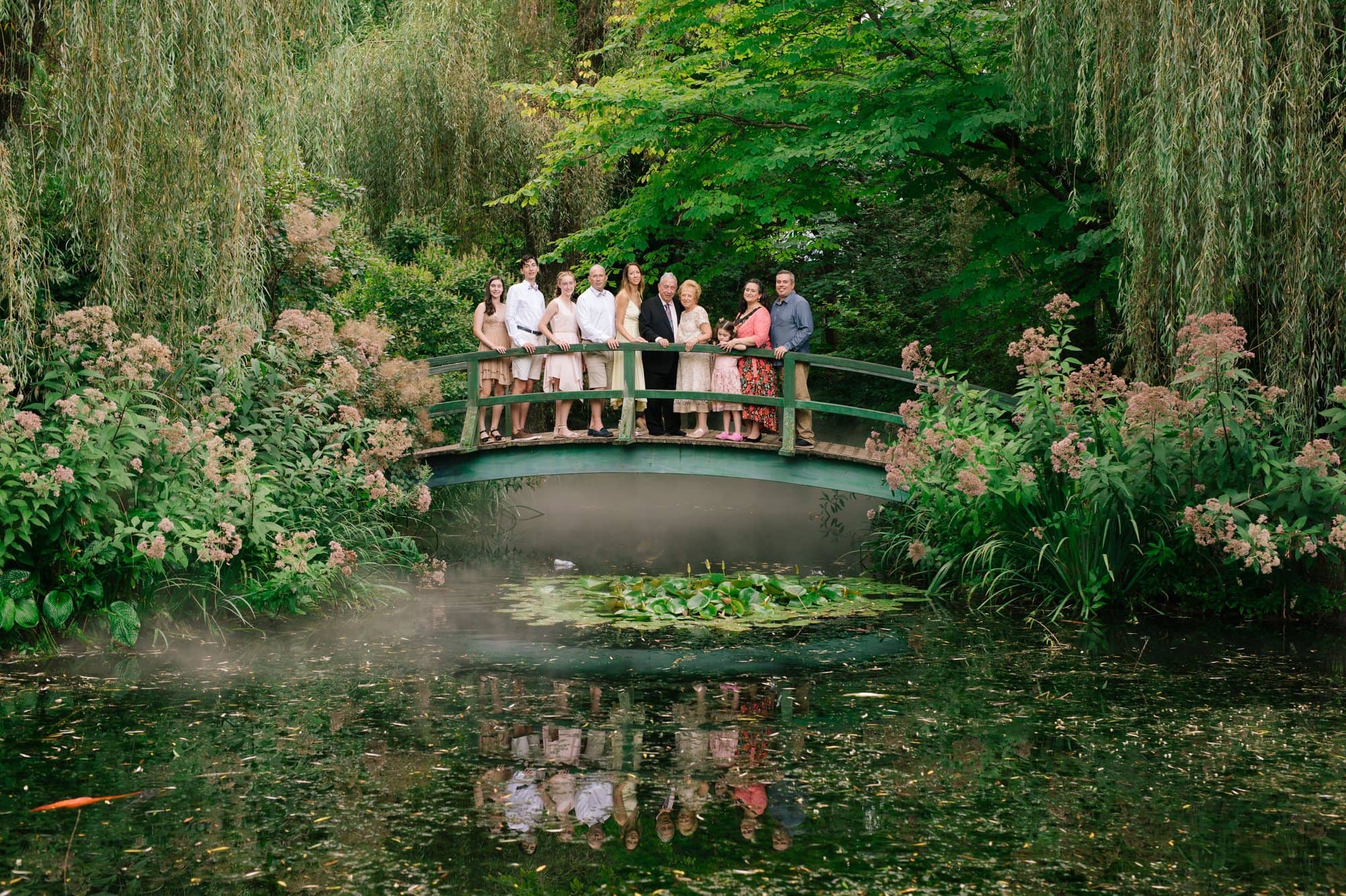Three generations of family on the Monet bridge at a 50th wedding anniversary celebration at Grounds for Sculpture