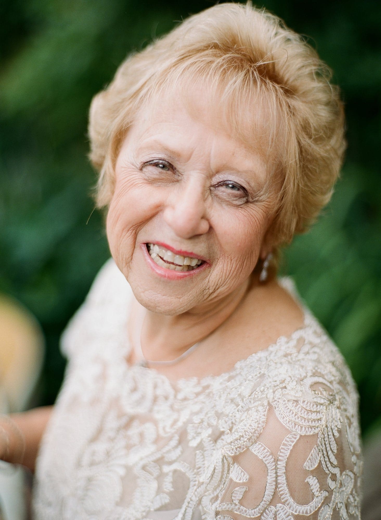 A joyful portrait of a woman in lace at her 50th wedding anniversary vow renewal in New Jersey