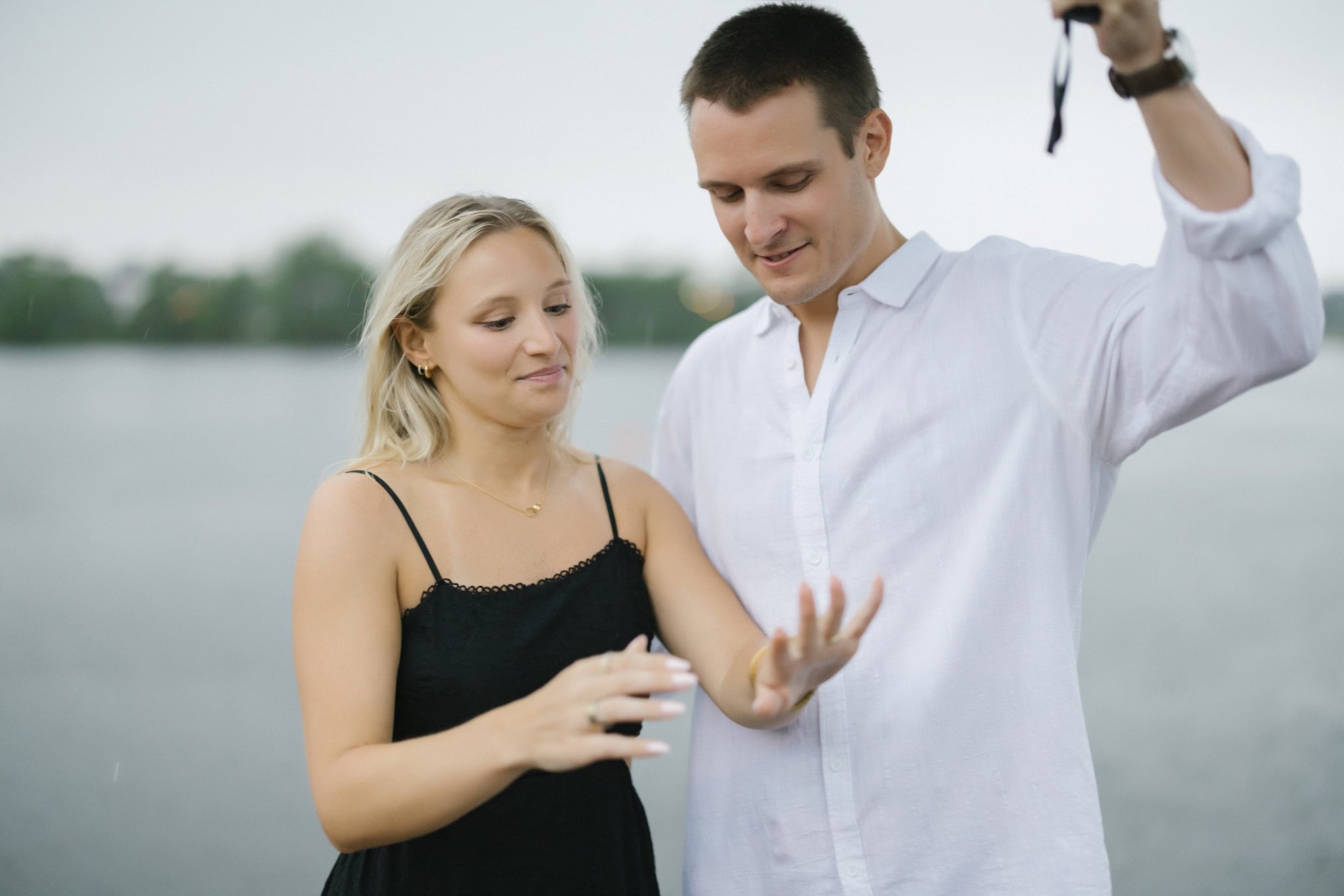 Bride to be admiring her engagement ring beside Twilight Lake in Bay Head NJ