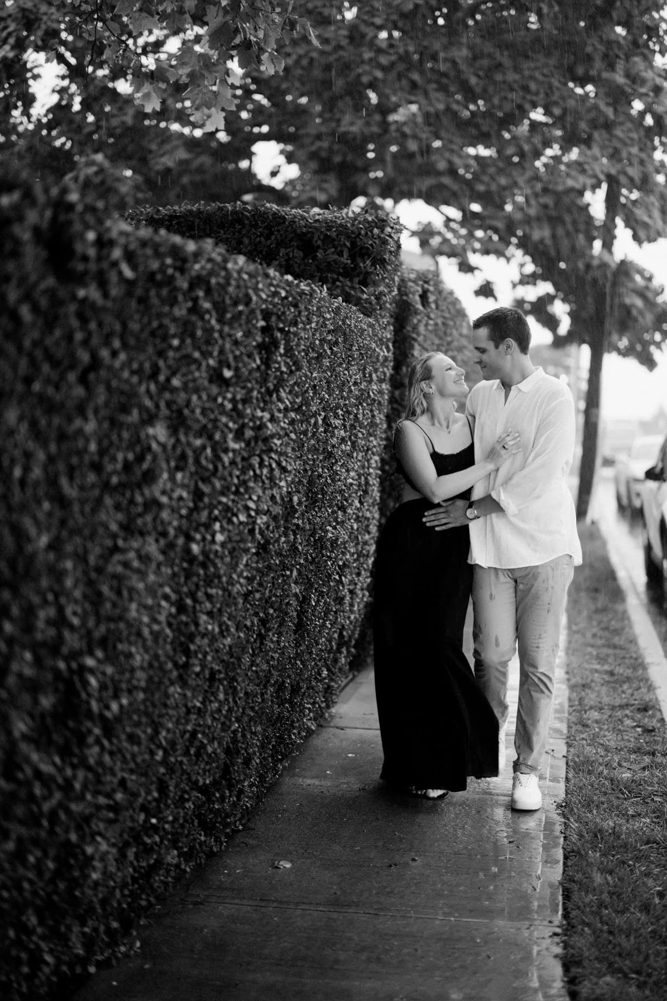 Black and white portrait of a newly engaged couple in the rain in Bay Head NJ