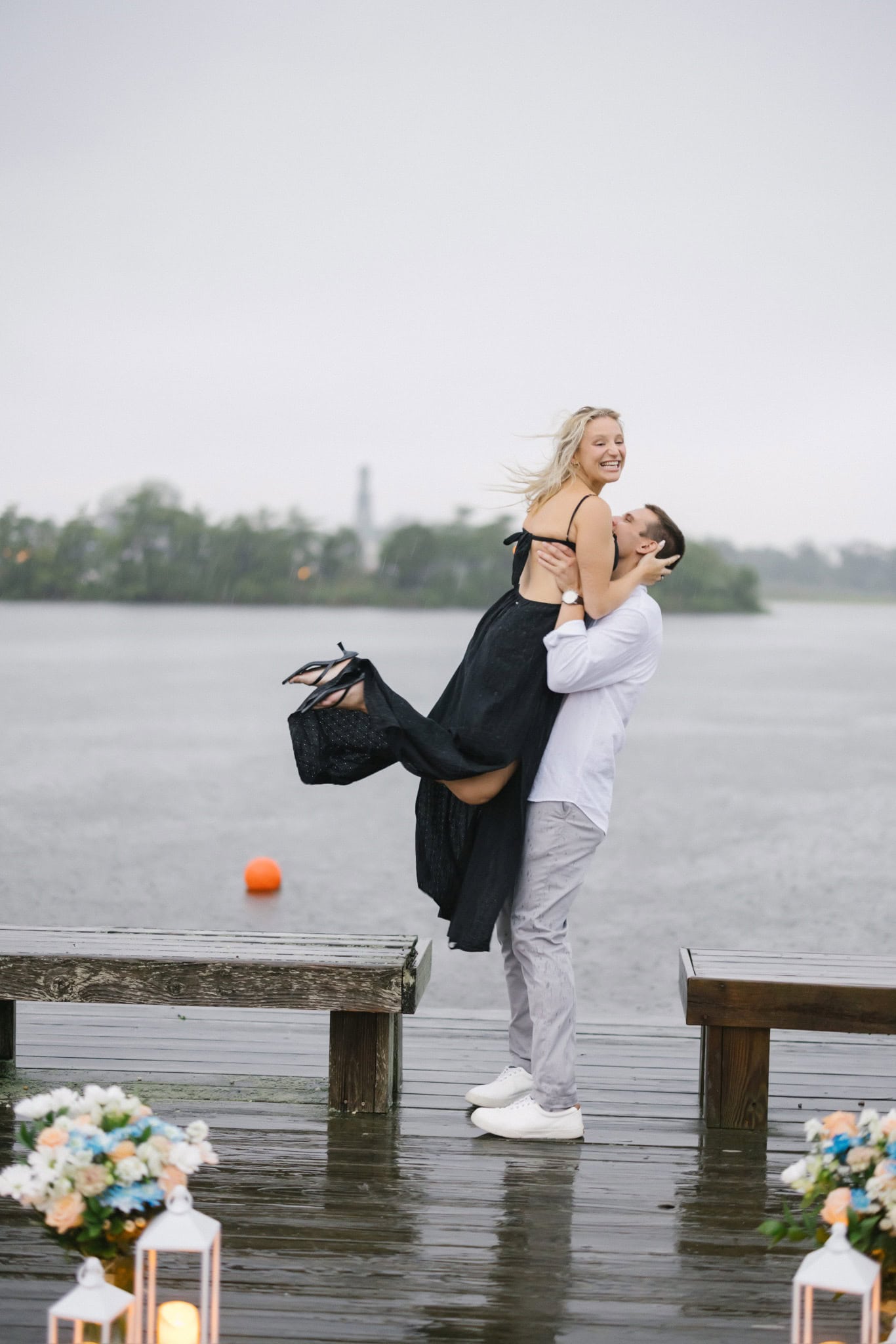 Groom lifting his fiancee in celebration on a Twilight Lake dock after a surprise proposal in Bay Head NJ