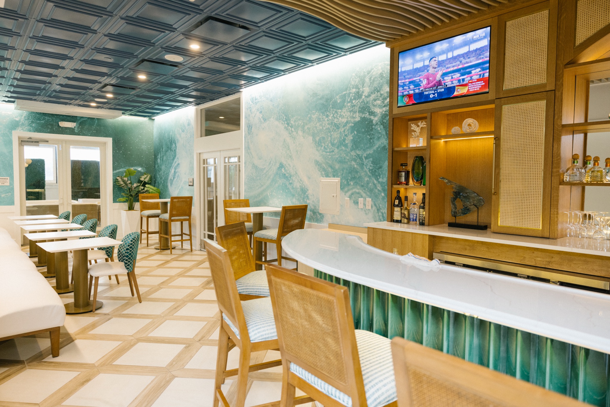 Renovated beach club bar and lounge at ICONA Avalon in Avalon NJ with an ocean wave mural and coastal seating