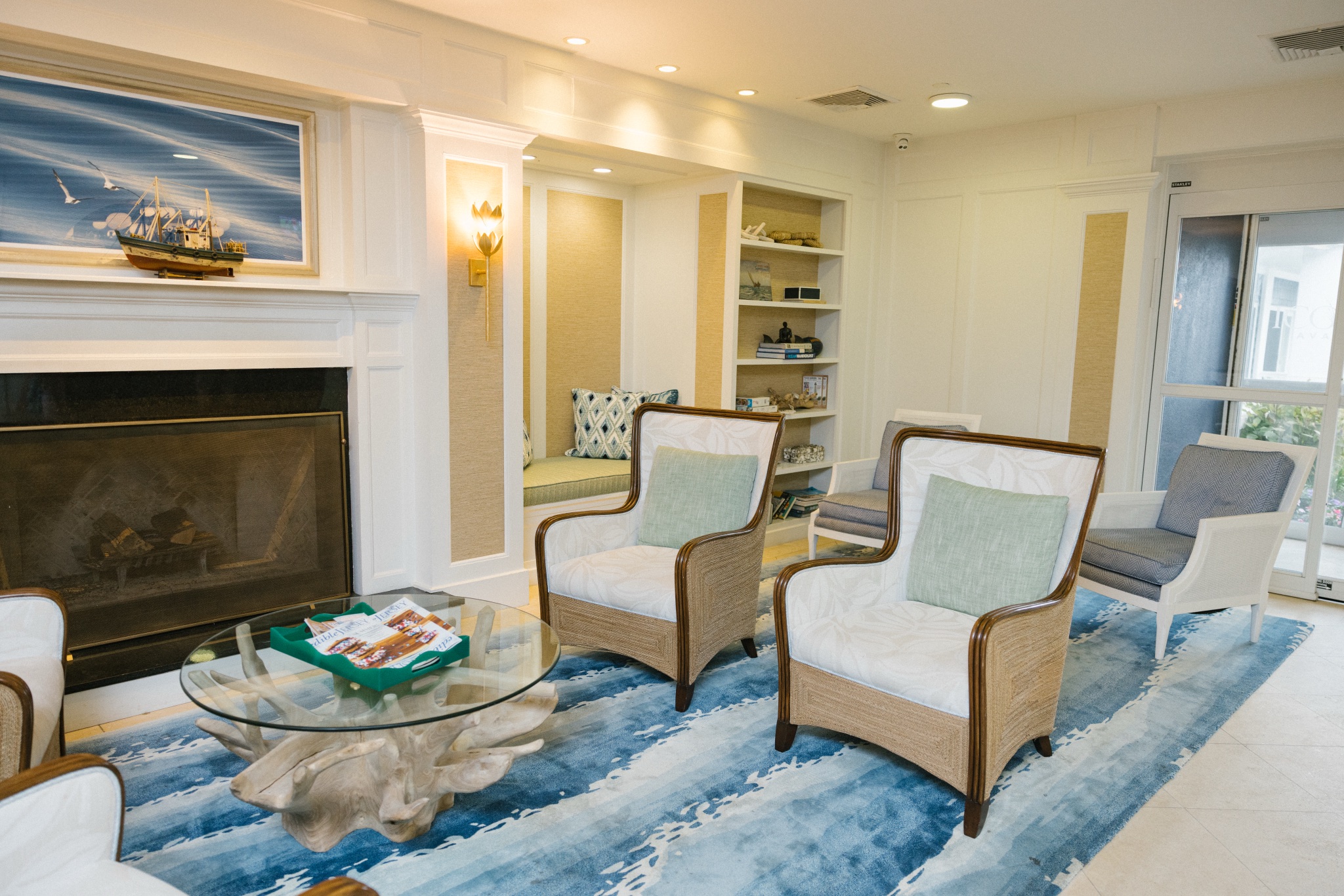 Renovated fireplace lobby lounge at ICONA Avalon in Avalon NJ with coastal seating and sailboat artwork