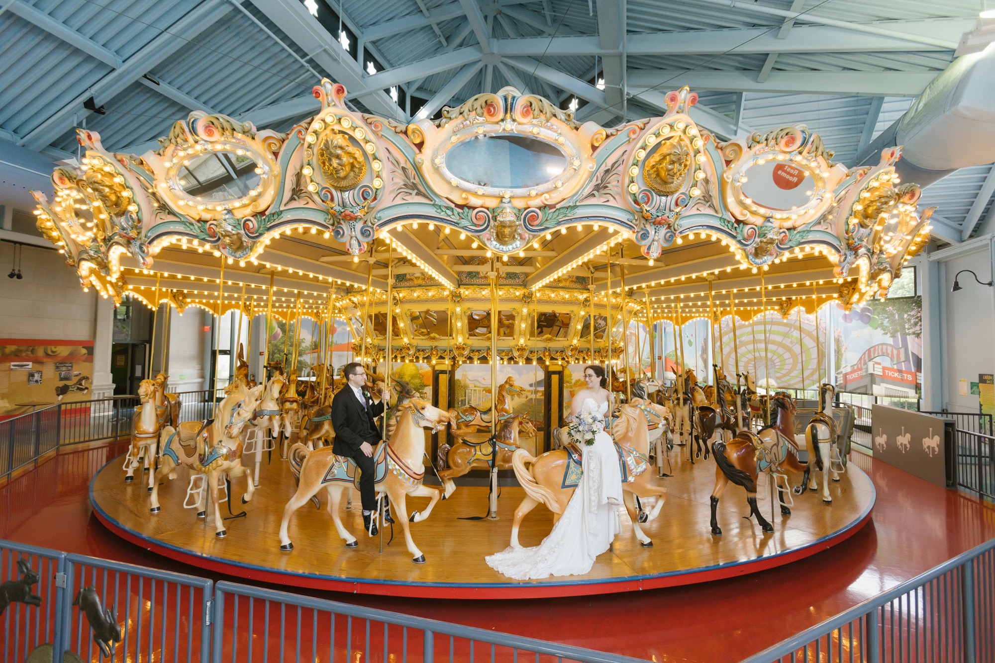 Bride and groom on the Grand Carousel at their Please Touch Museum wedding in Philadelphia