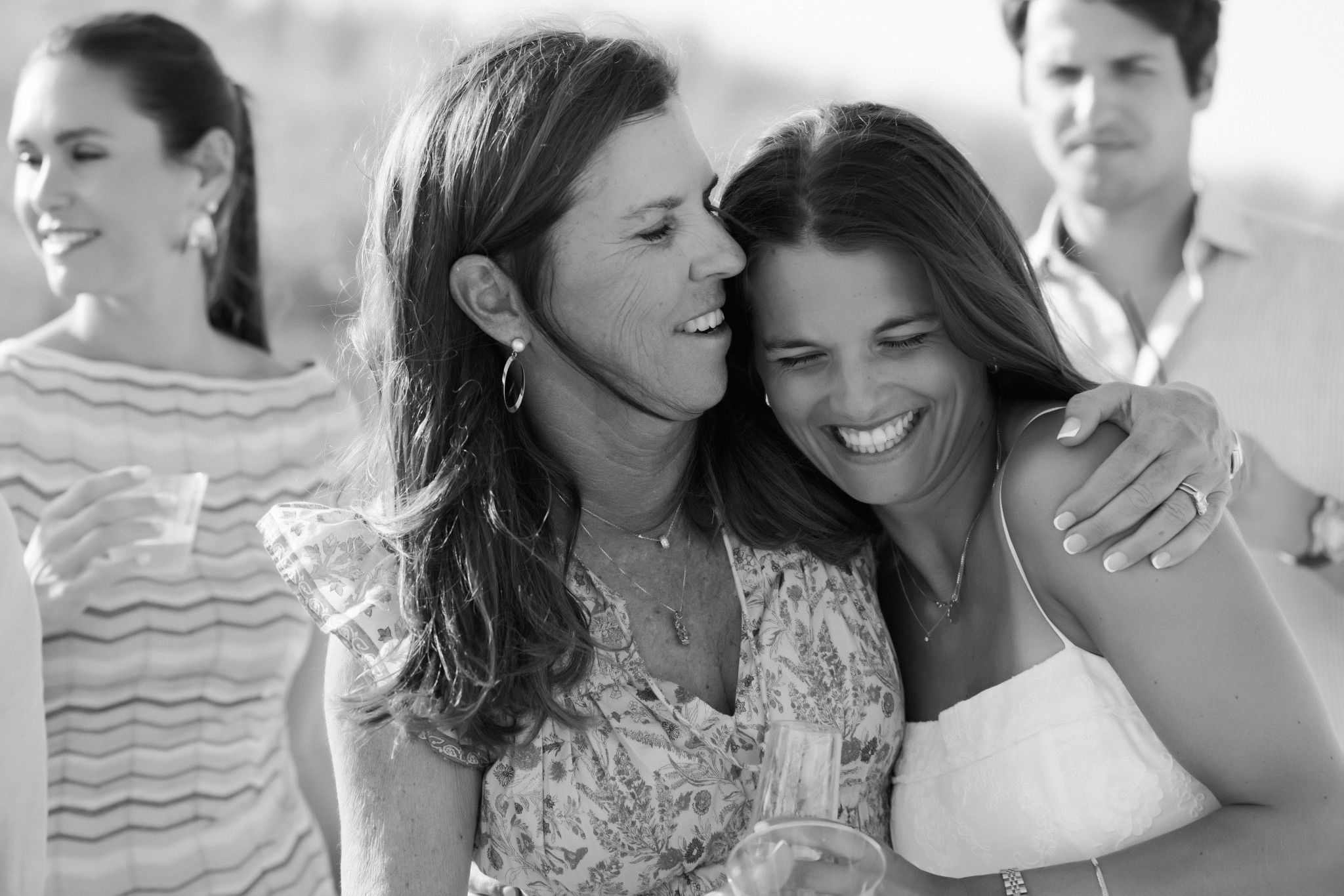 Black and white photograph of Katie hugging her mom after the proposal on the beach in Stone Harbor, New Jersey