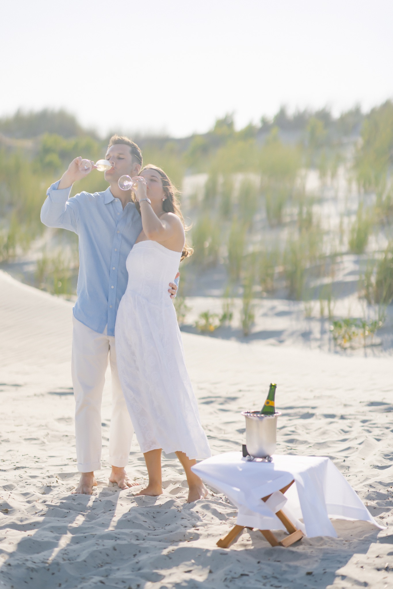 Katie and Chris toasting with champagne glasses on the beach in Stone Harbor, New Jersey