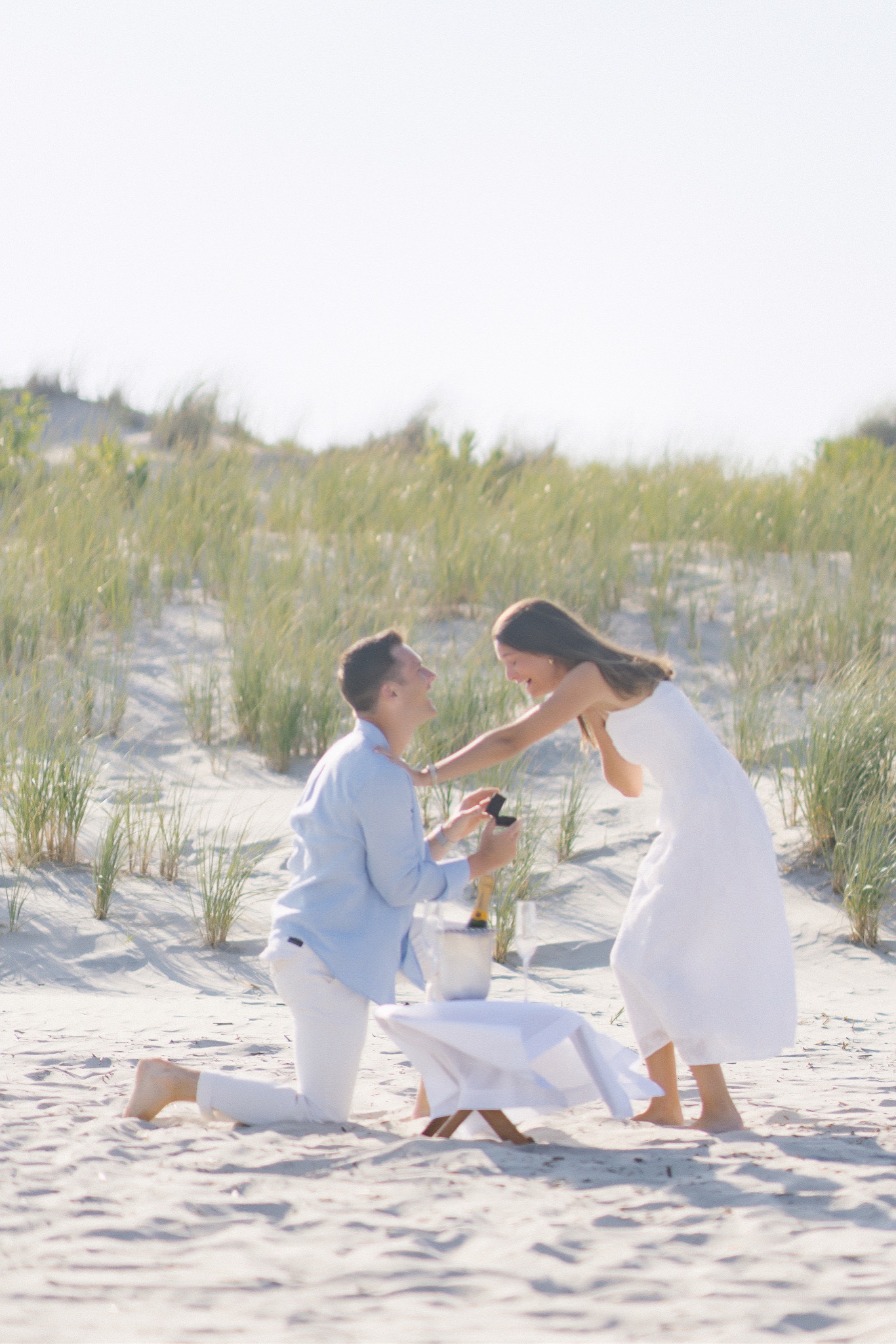 Chris down on one knee proposing to Katie on the beach in Stone Harbor, New Jersey