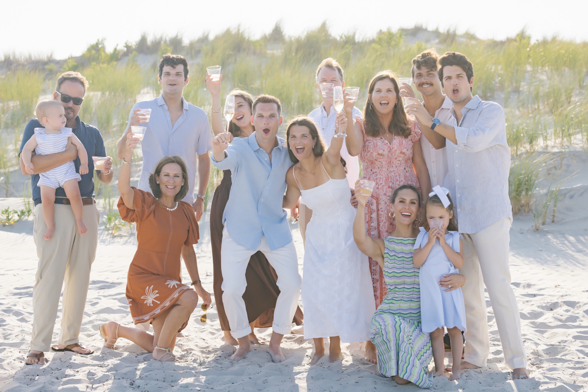 Katie, Chris and their family toasting with champagne on the beach in Stone Harbor, New Jersey