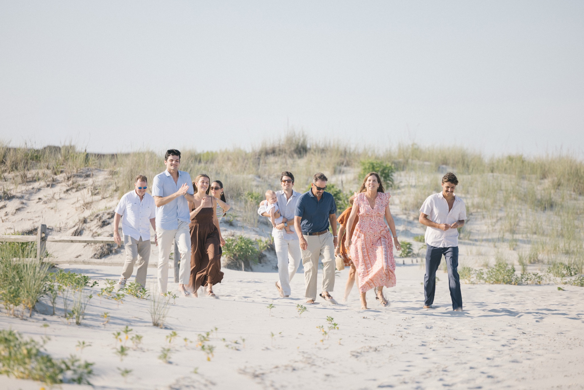 Katie and Chris's family walking down the beach to surprise them after the proposal in Stone Harbor, New Jersey