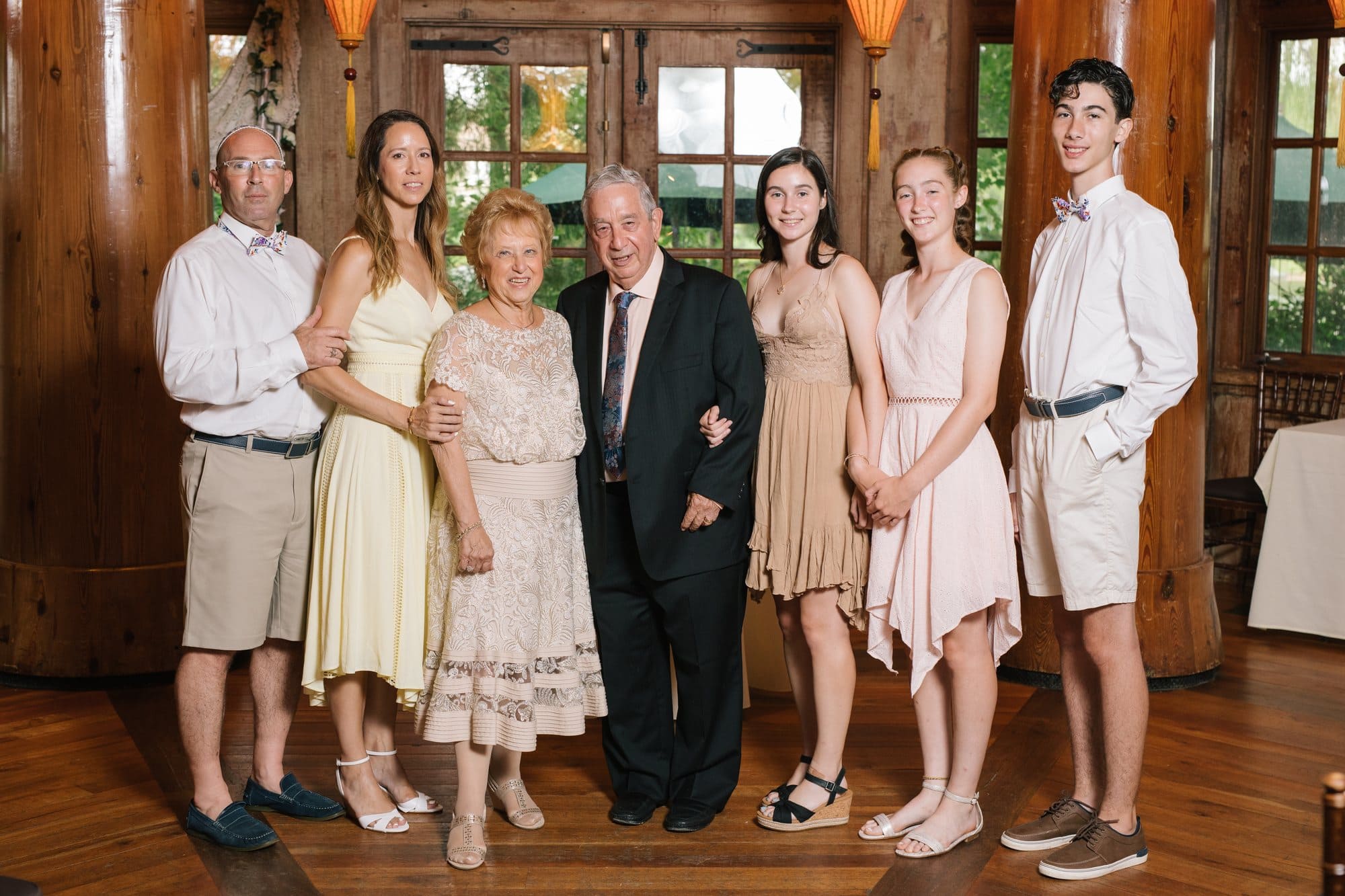 An extended family portrait in a timber ceremony room at a 50th anniversary vow renewal in New Jersey