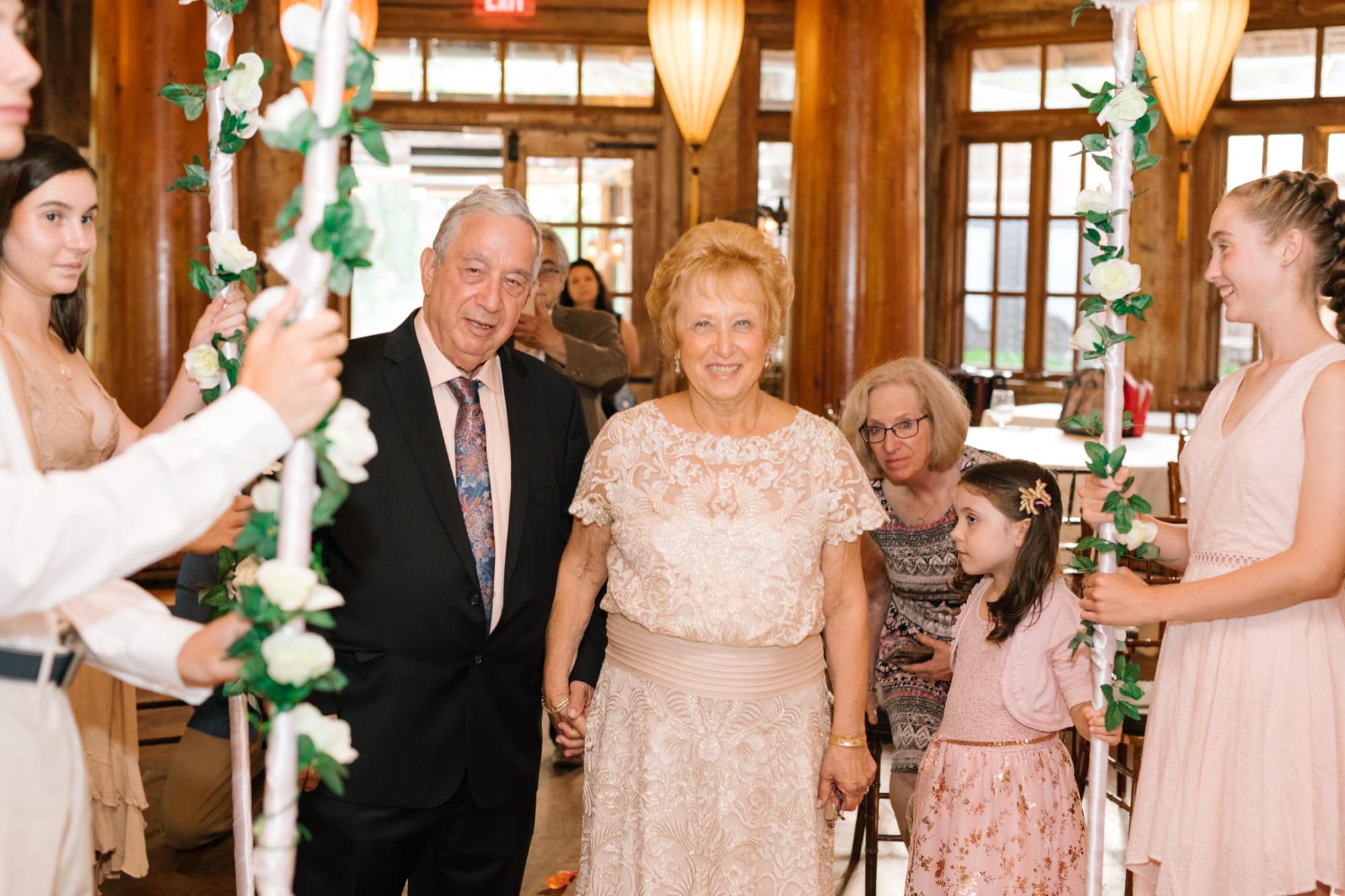 The processional carrying the chuppah poles at a Jewish vow renewal at Grounds for Sculpture