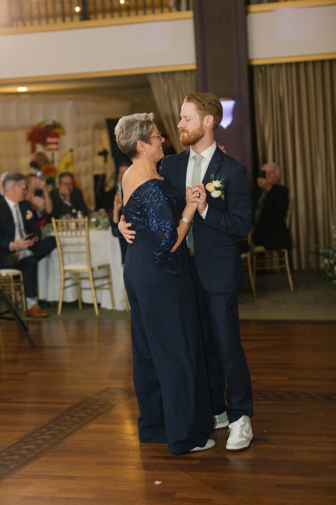 Parent dance beside the gold curtains in the Collingswood Grand Ballroom