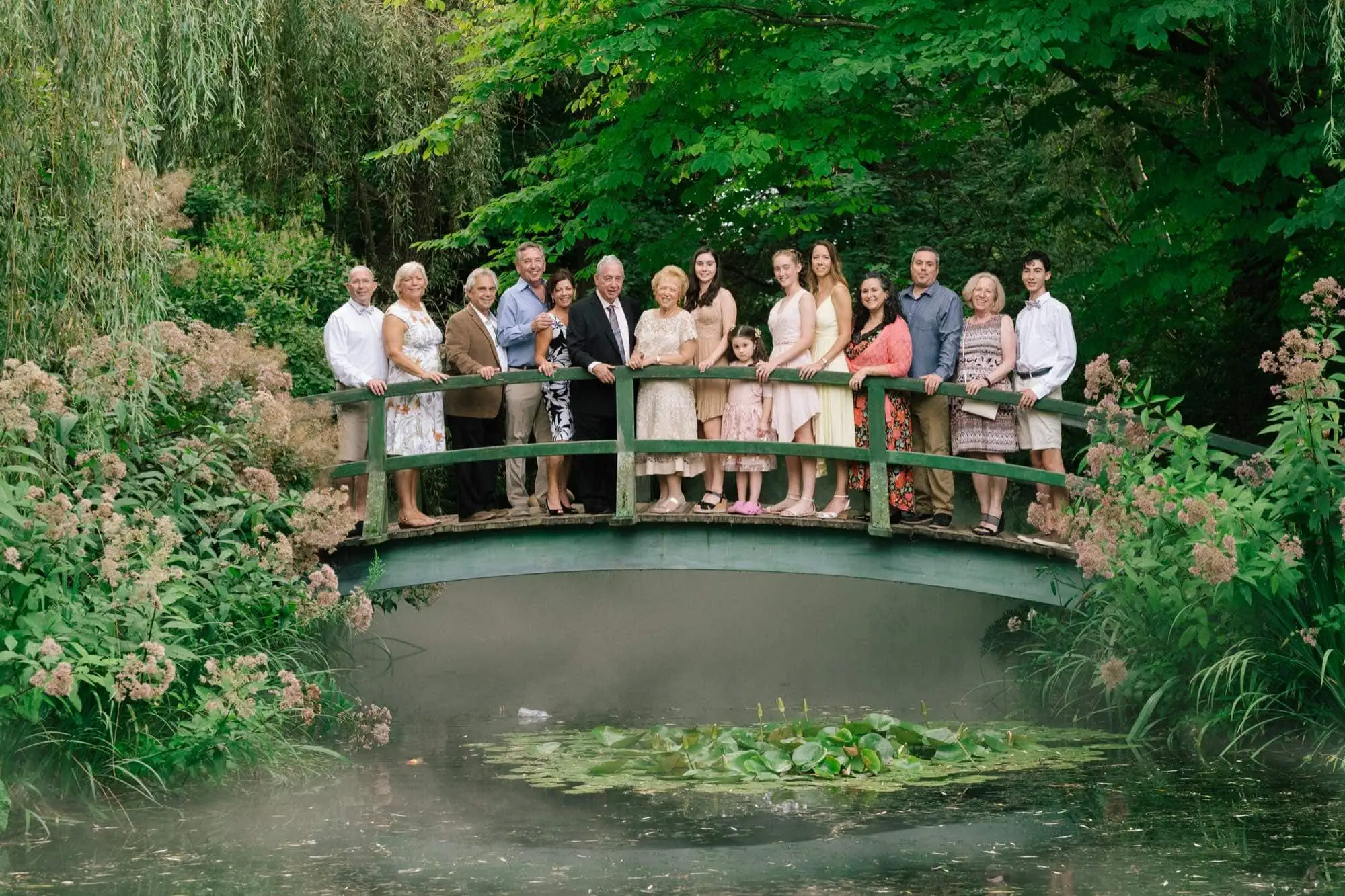 A family gathered on the Monet bridge at Grounds for Sculpture for a fiftieth anniversary vow renewal