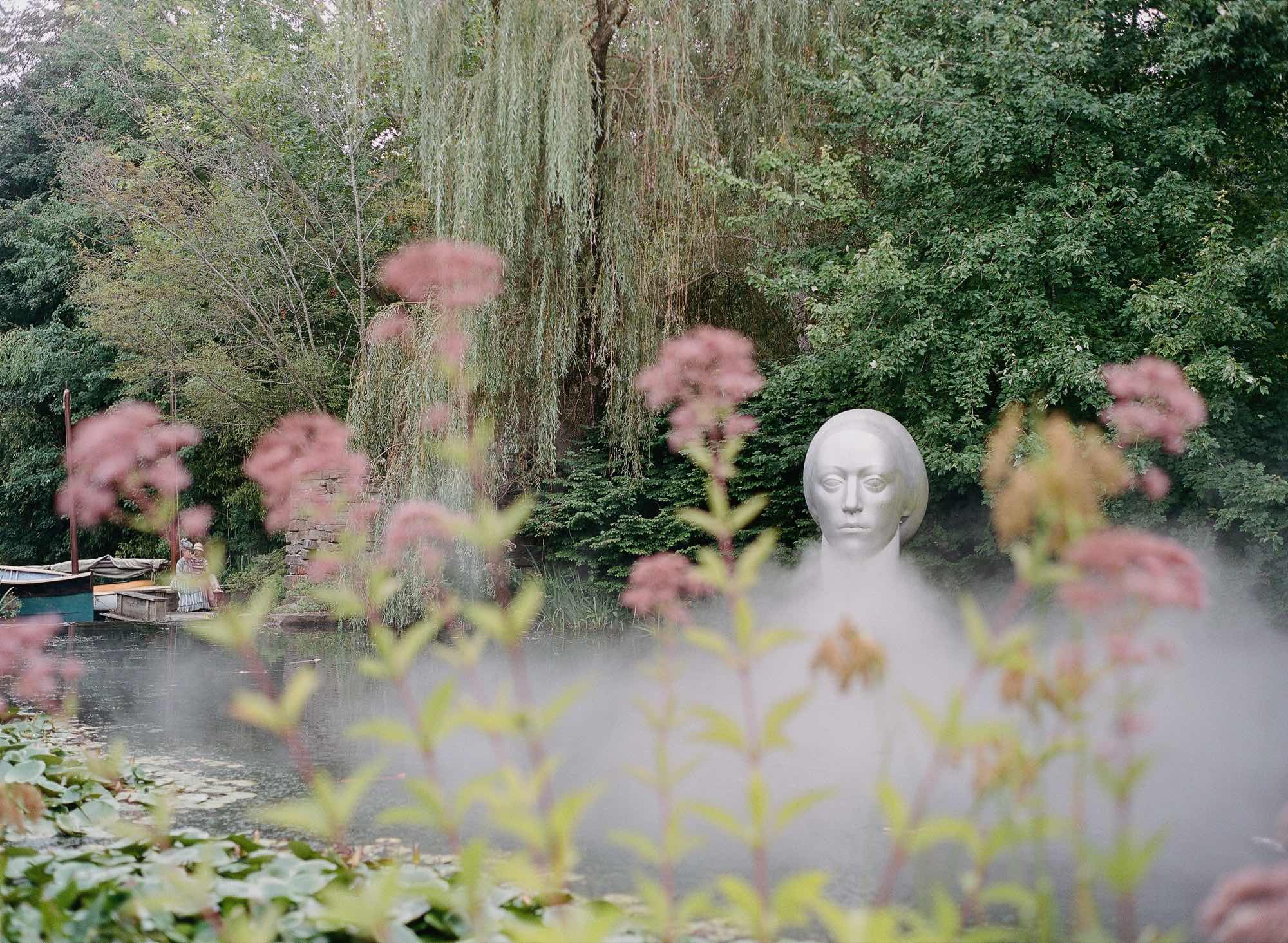 Mist rising off the lily pond beside a sculpture at Grounds for Sculpture in Hamilton, New Jersey