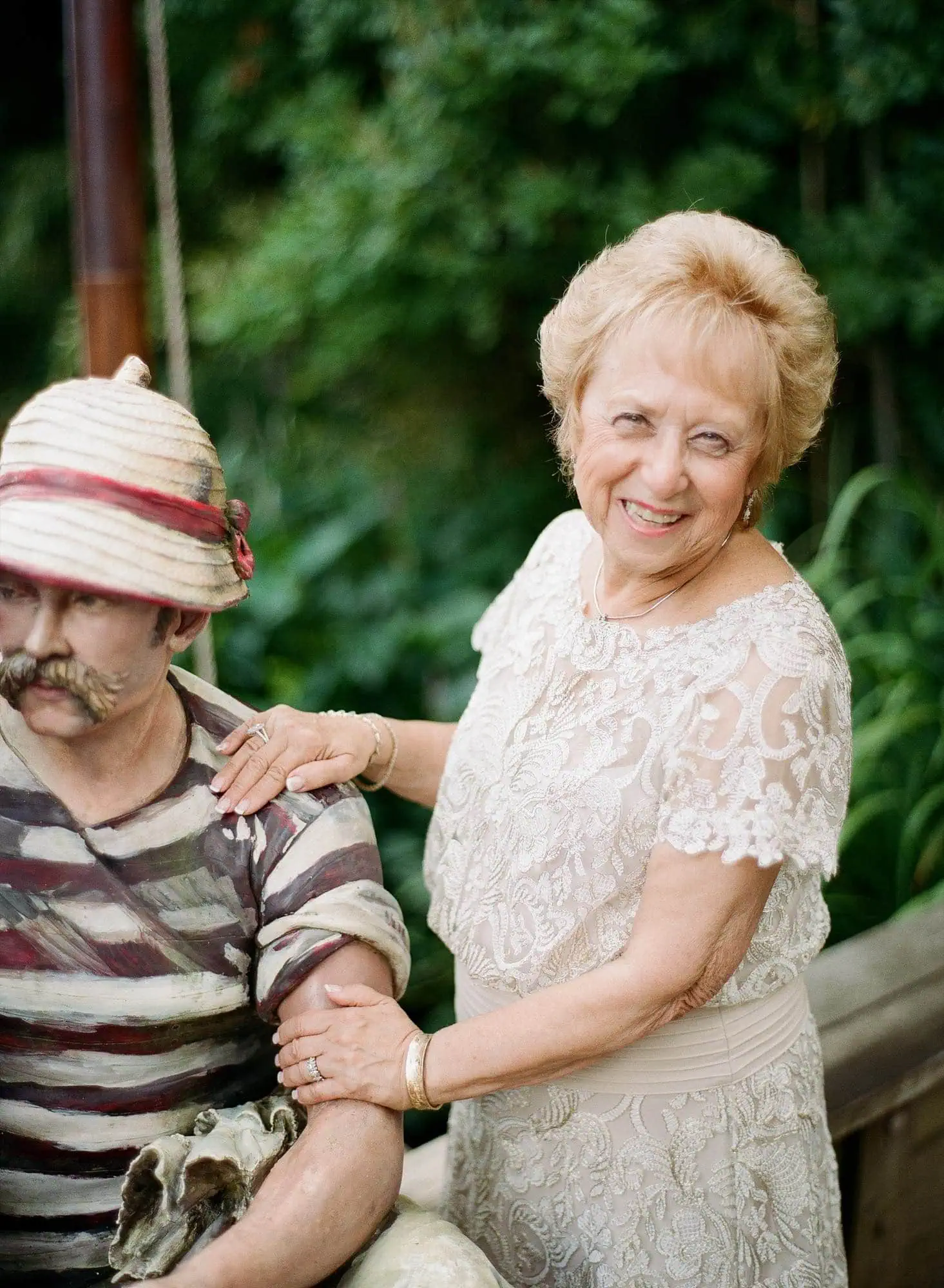 A portrait of an older woman among the sculptures at Grounds for Sculpture, photographed on film